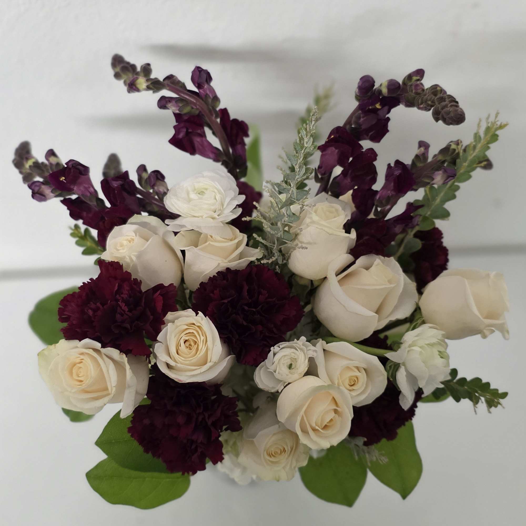 The Burgundy Beauty is a rich design with burgundy snap dragons, white