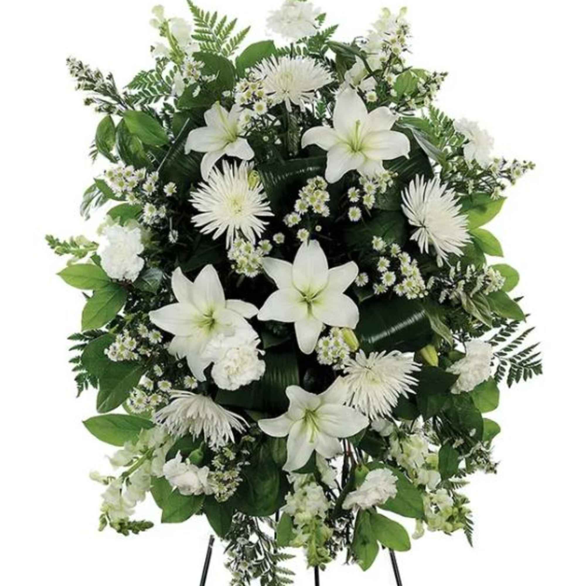 A standing spray of assorted white flowers spread across a bed of A standing spray of assorted white flowers spread across a bed of