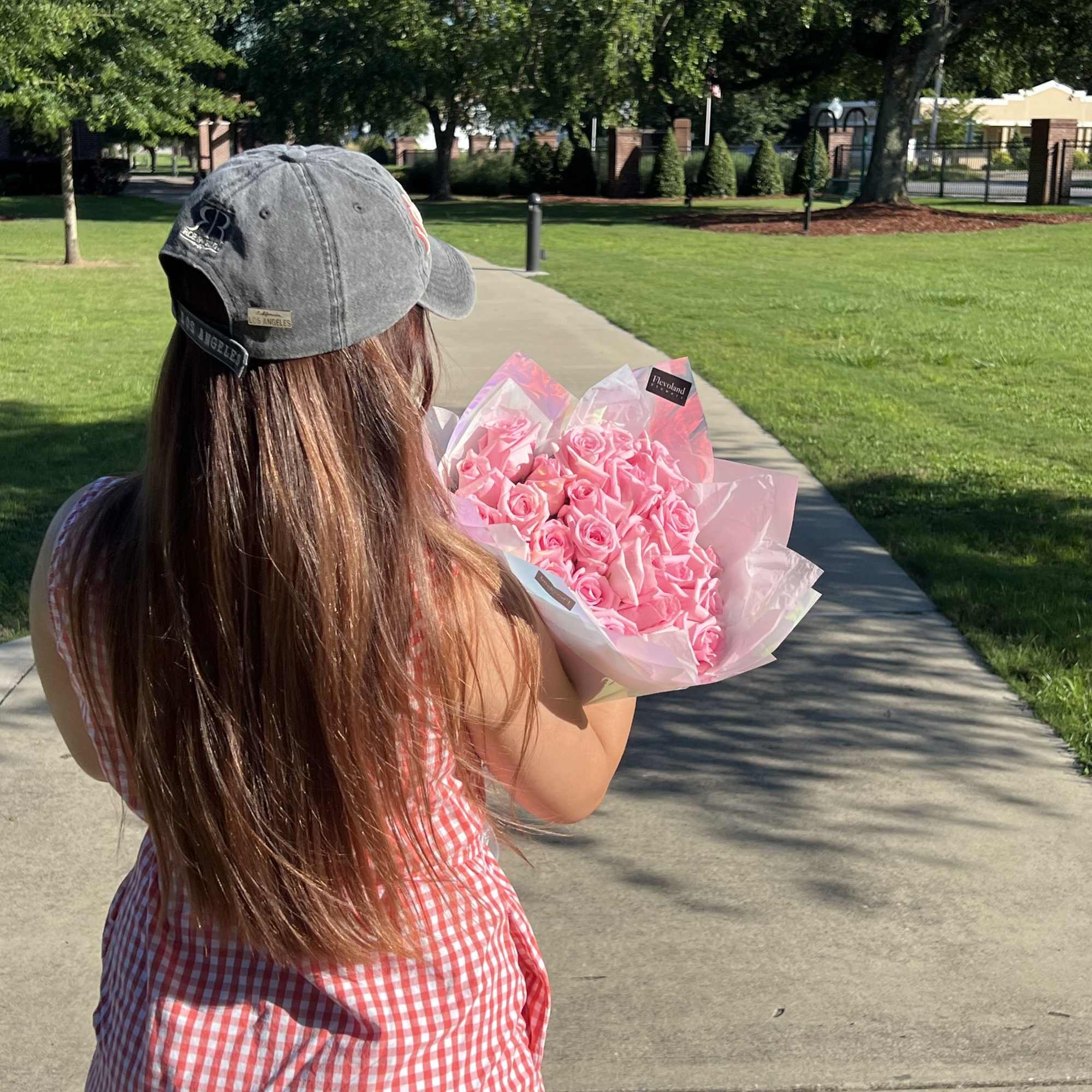 A timeless bouquet of classic pink roses, elegantly wrapped in paper to