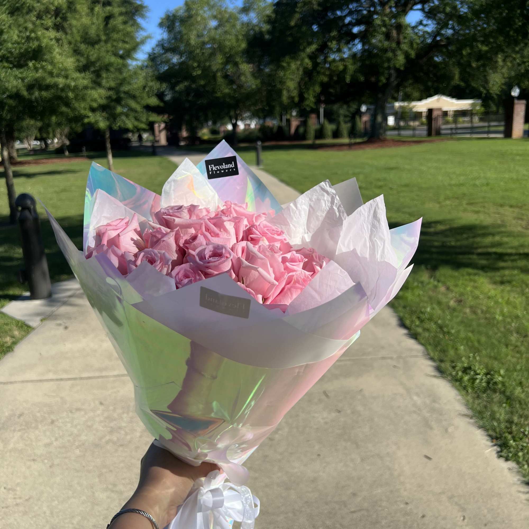 A timeless bouquet of classic pink roses, elegantly wrapped in paper to
