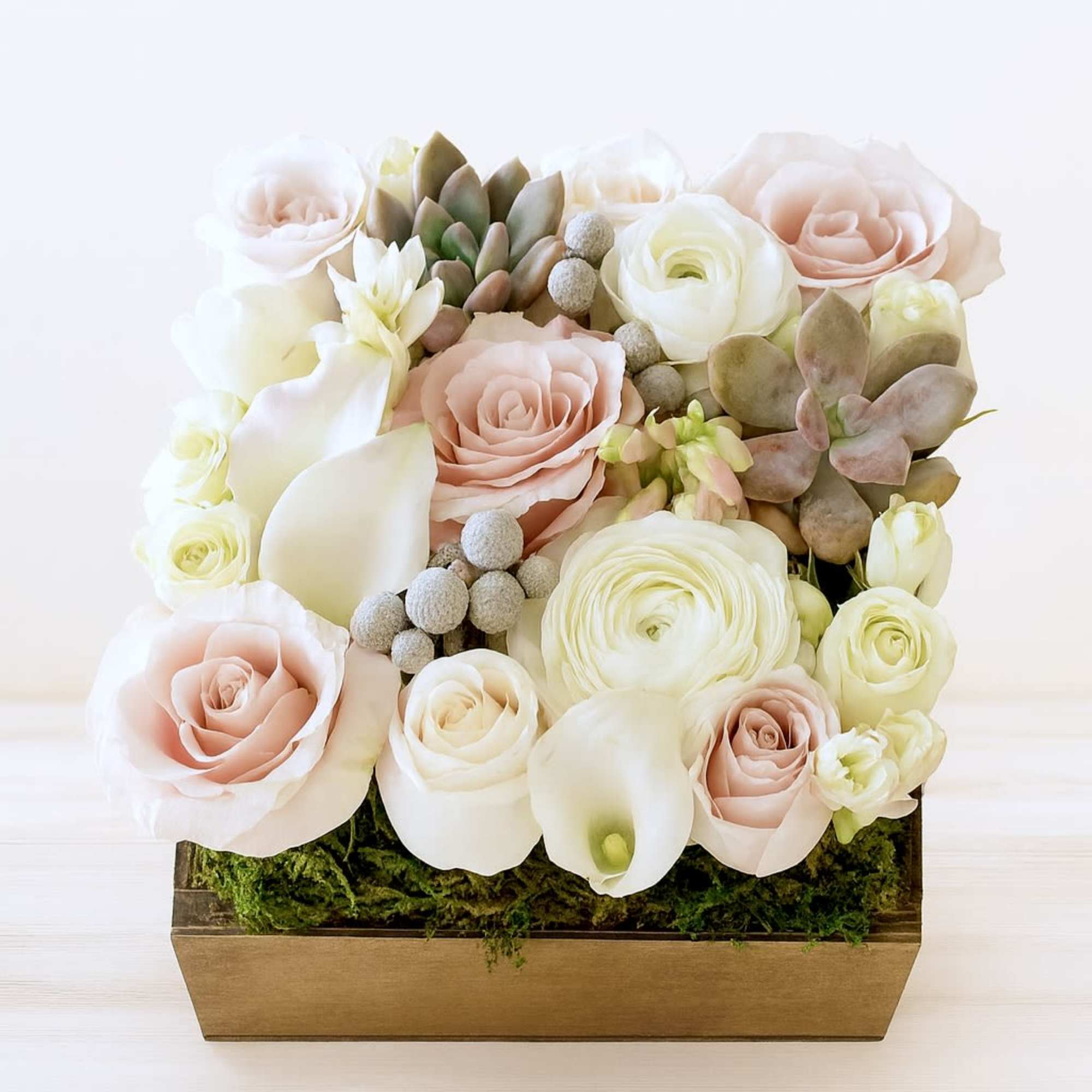 Beautifully designed arrangement in a 7"X 7" square wood box with ivory