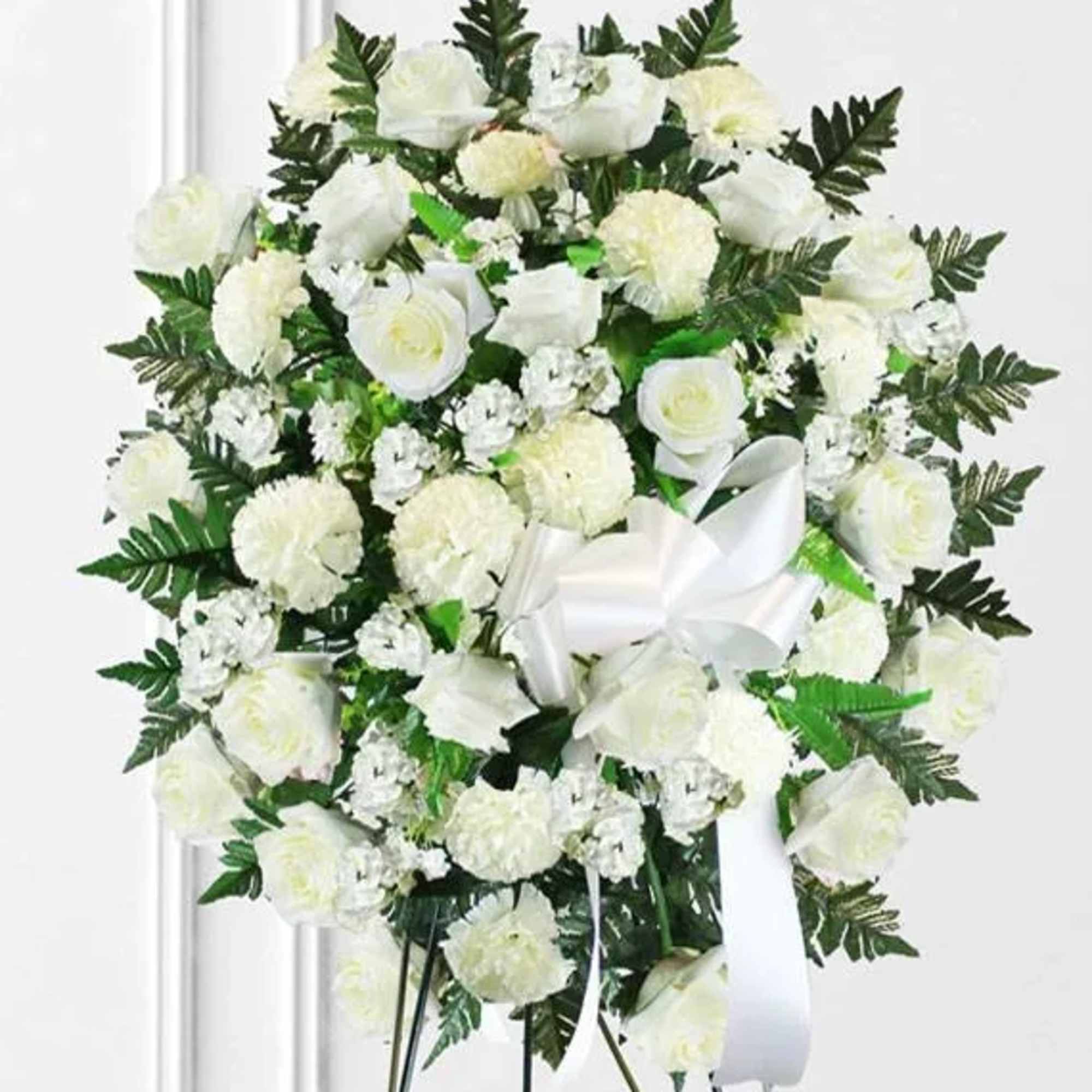 A graceful and elegant standing spray crafted in pristine white blooms, symbolizing
