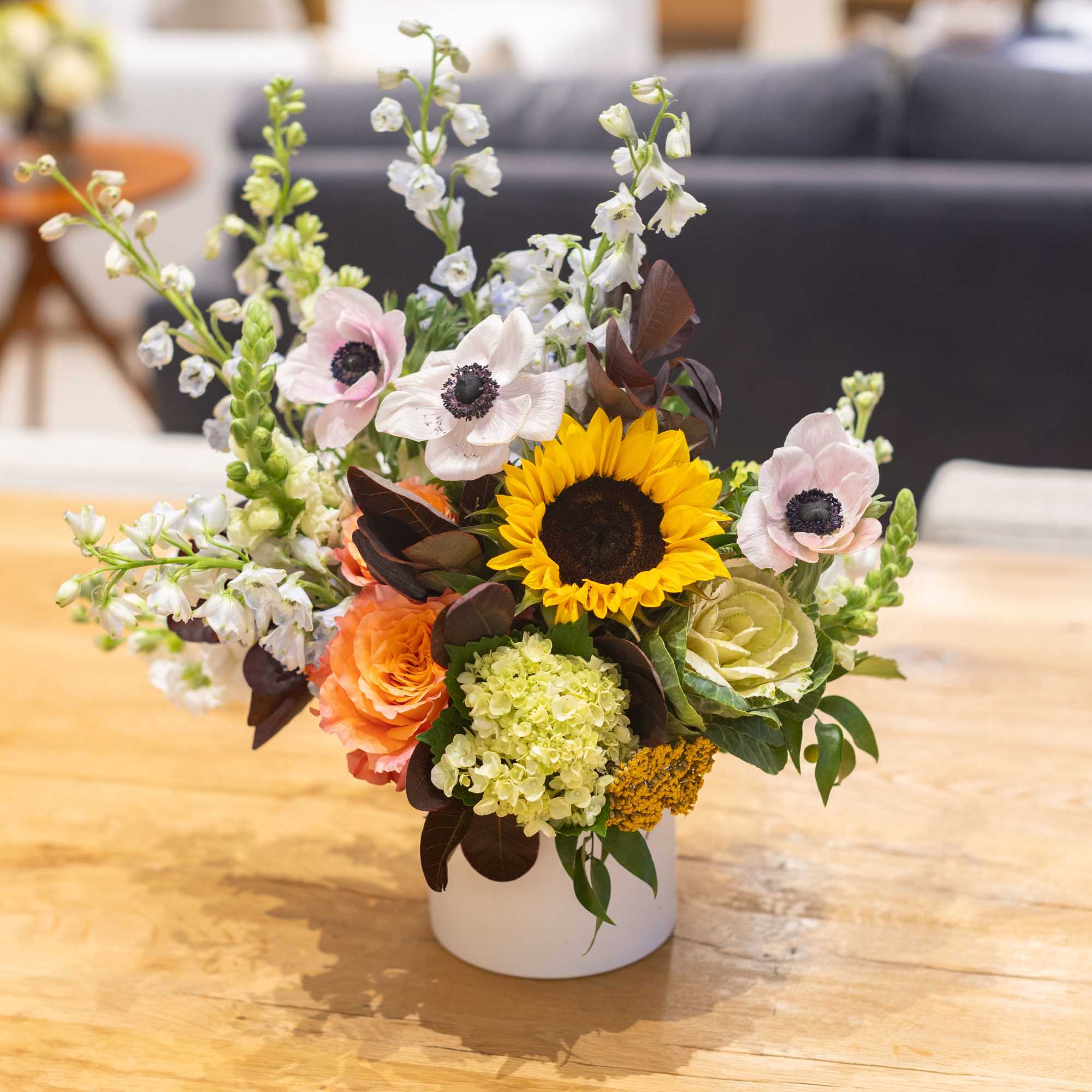 A fresh floral arrangement with season tones and blooms. The perfect centerpiece