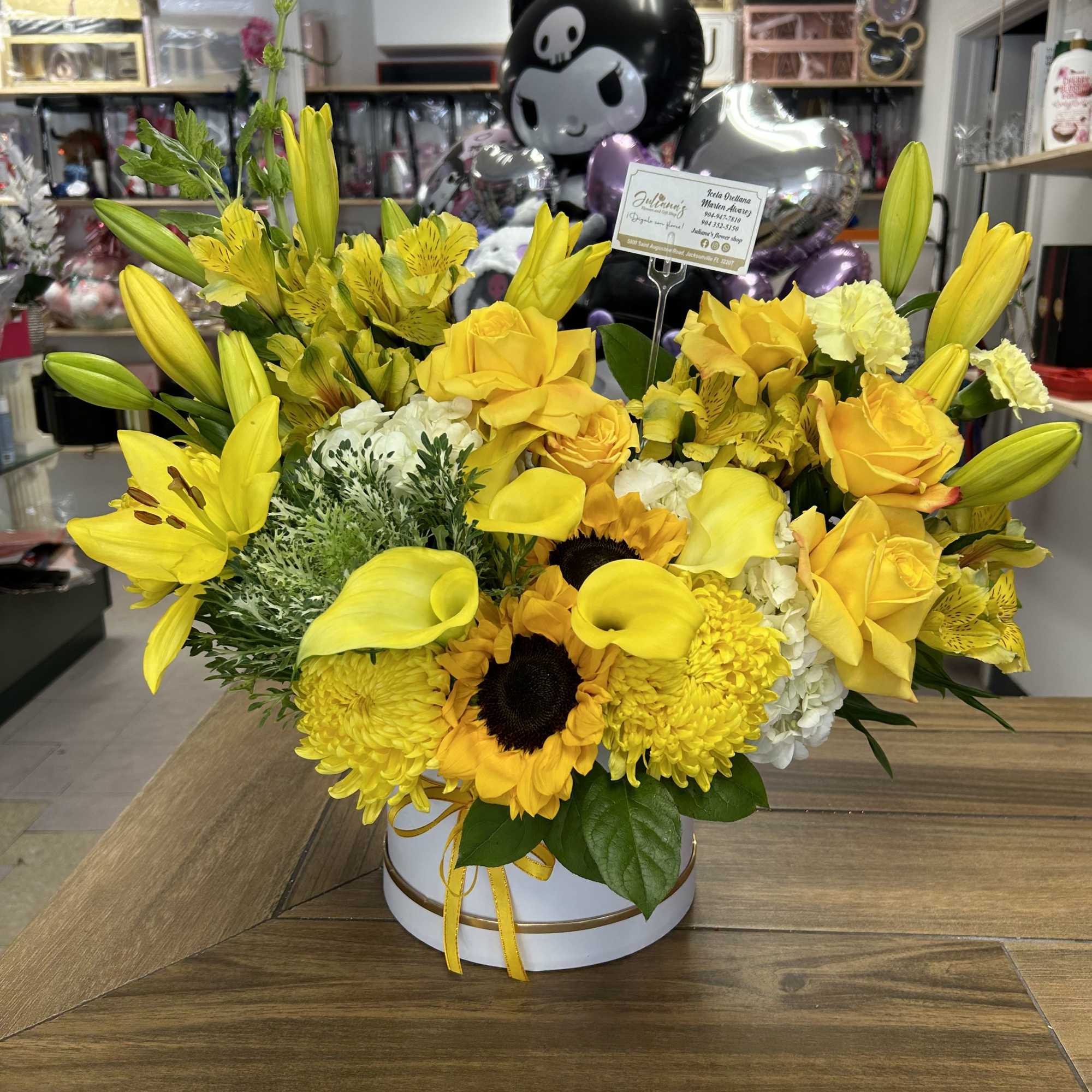 Medium round box with seasonal flowers in yellow colors