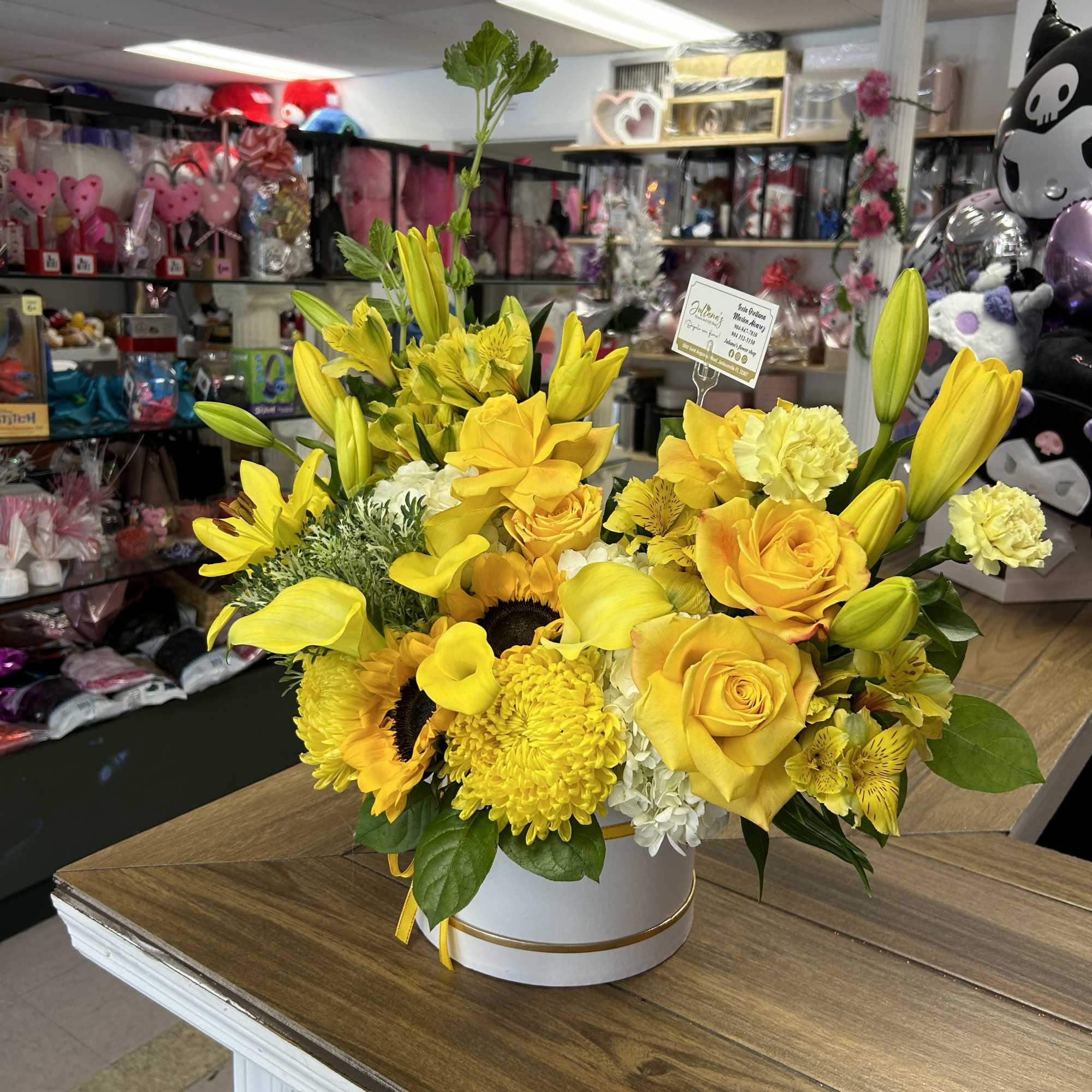 Medium round box with seasonal flowers in yellow colors