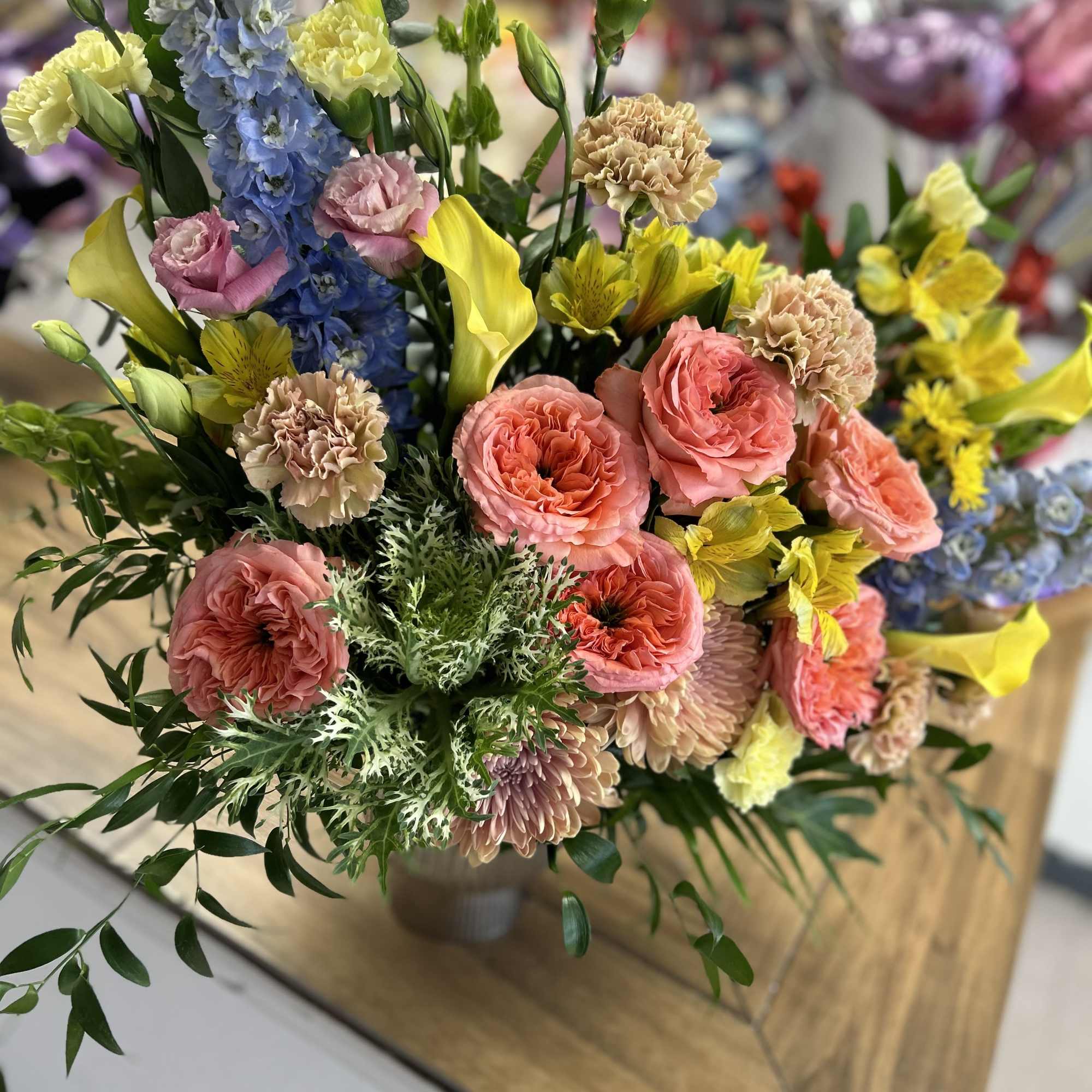 Beautiful and Delicate floral arrangement in spring colors!! Roses, chrysanthemums, alstroemerias, dolphins