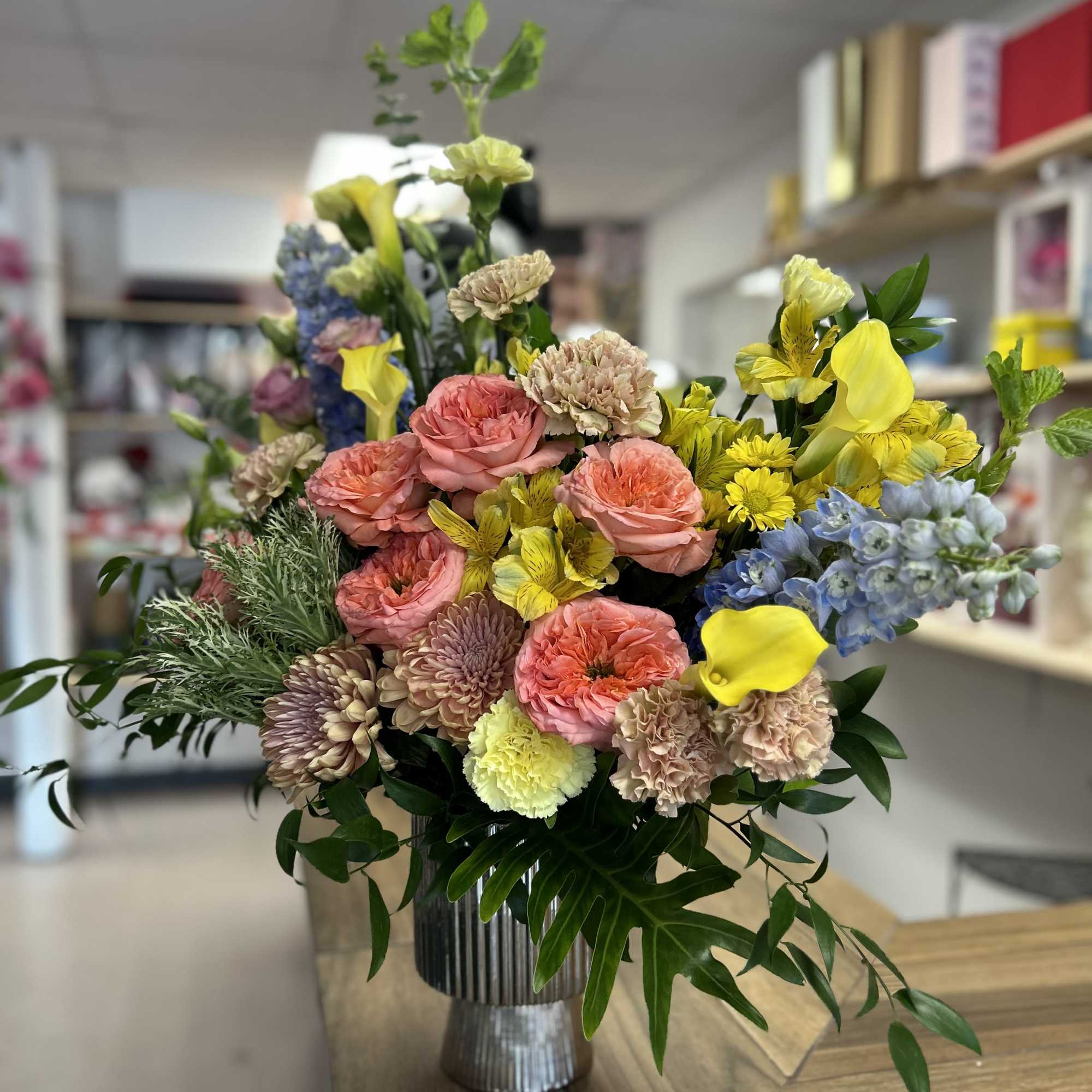 Beautiful and Delicate floral arrangement in spring colors!! Roses, chrysanthemums, alstroemerias, dolphins