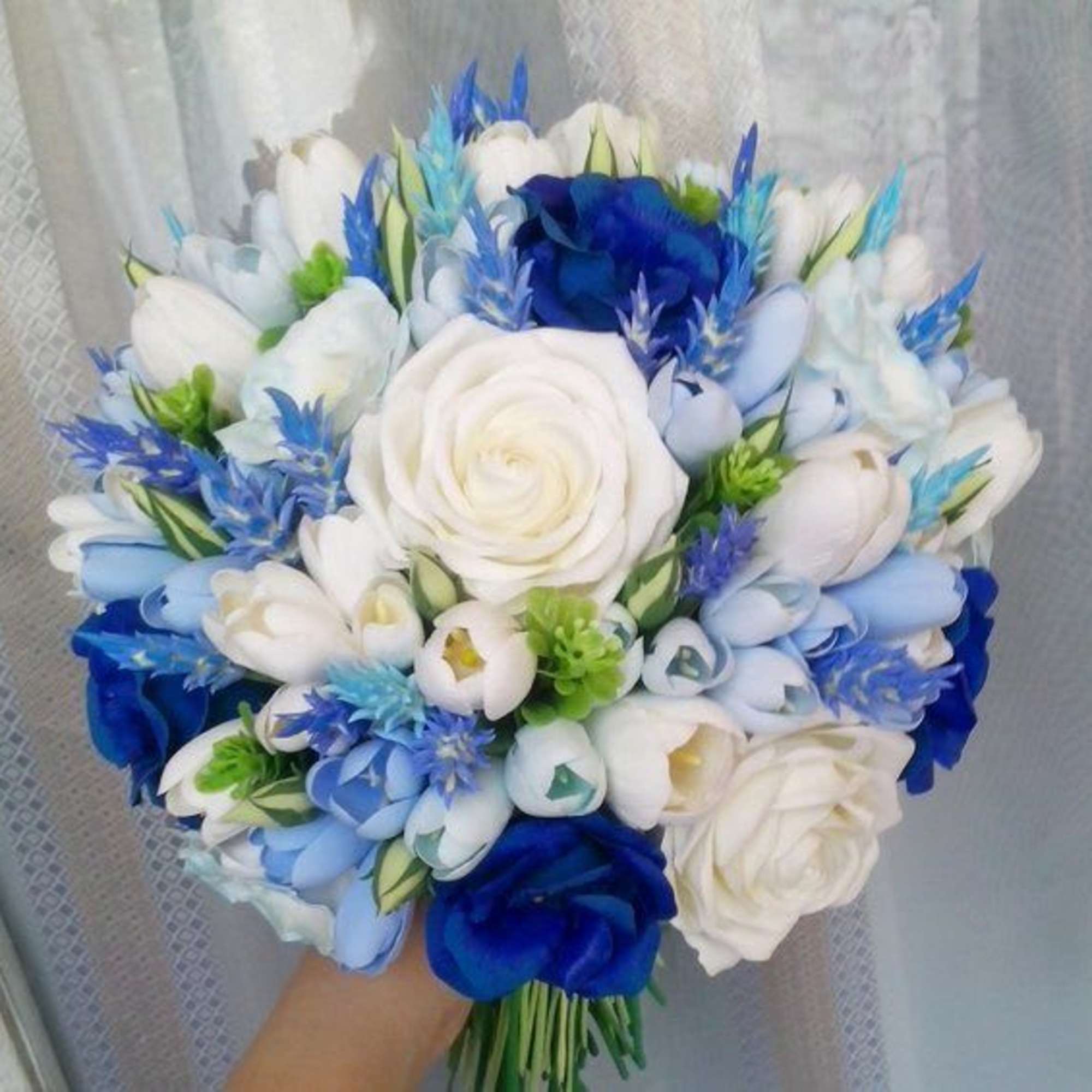 white roses, blue tulips, and green eucalyptus