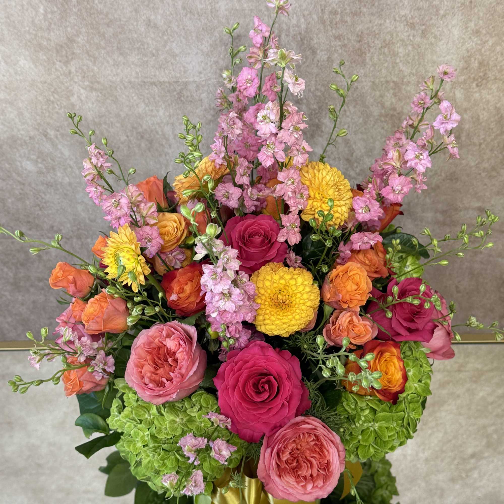 A vibrant, joyful burst of color, the Bright Garden arrangement is a