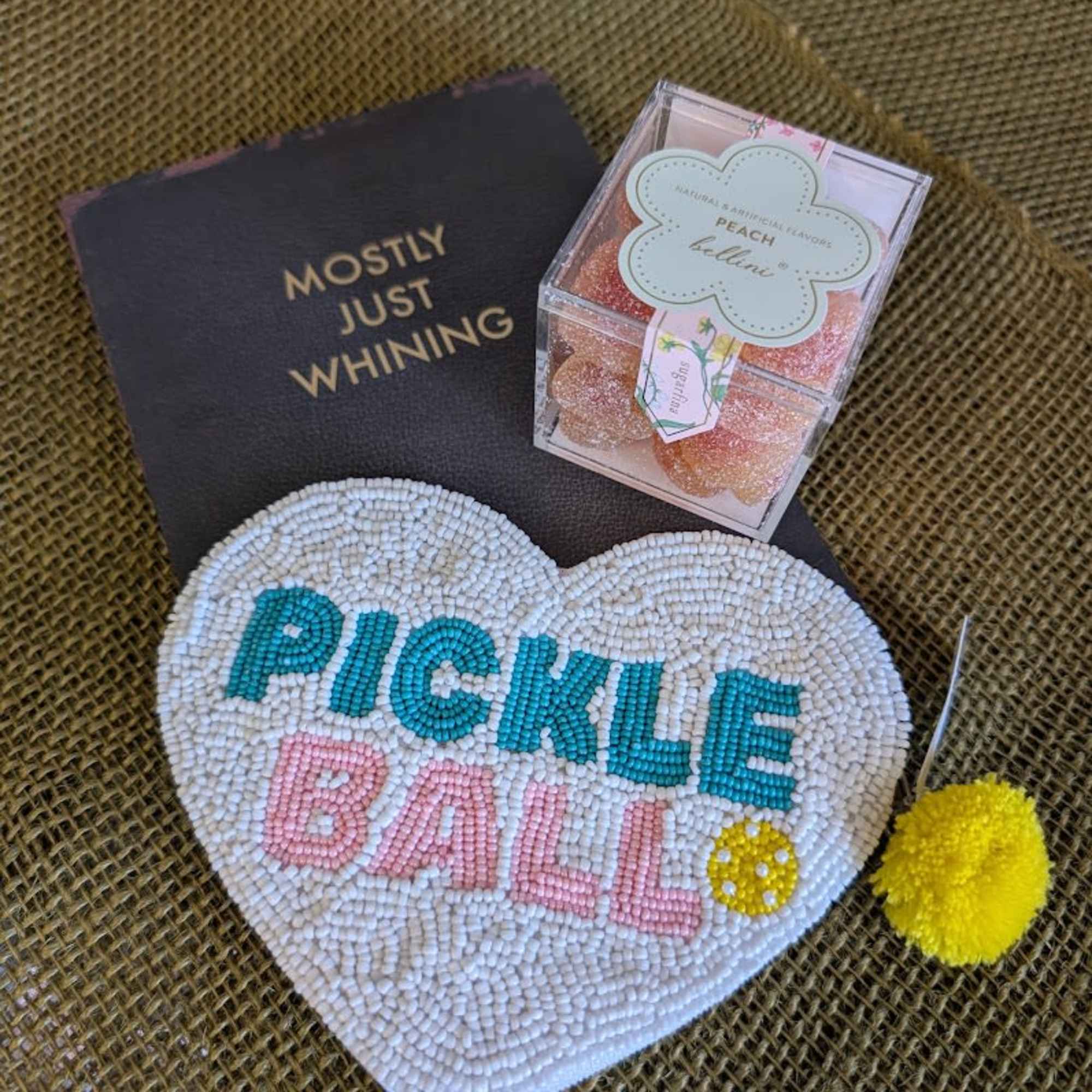 A cute bedazzled sequined pickleball change purse with a &quot;just whining&quot; notebook