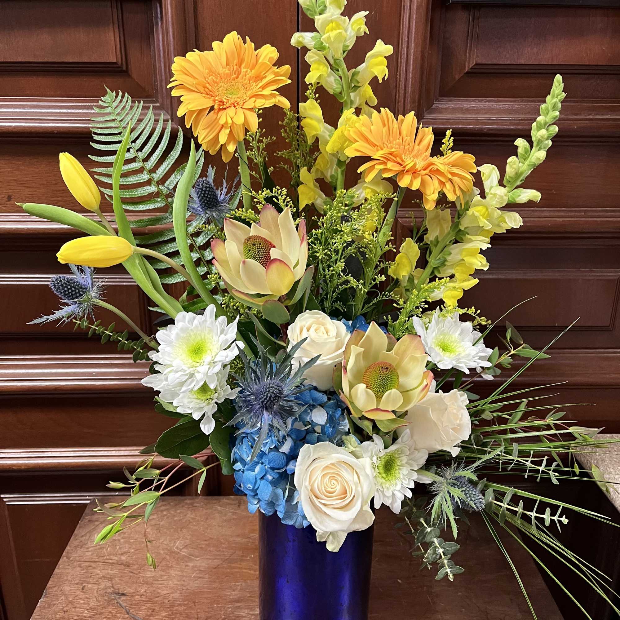 Recipe: Yellow Snapdragons, White Roses, Yellow Tulips, Orange Gerbera Daisies, Leucadendron Conebush