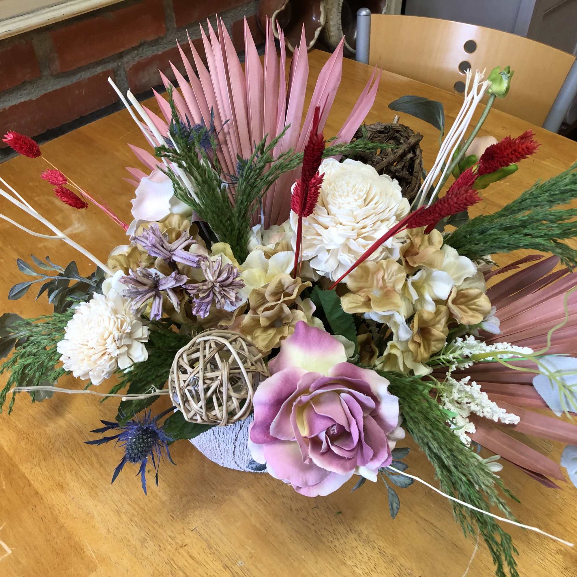 Silk and Dry Flowers arrangement wit hornatments in a plaster pot.