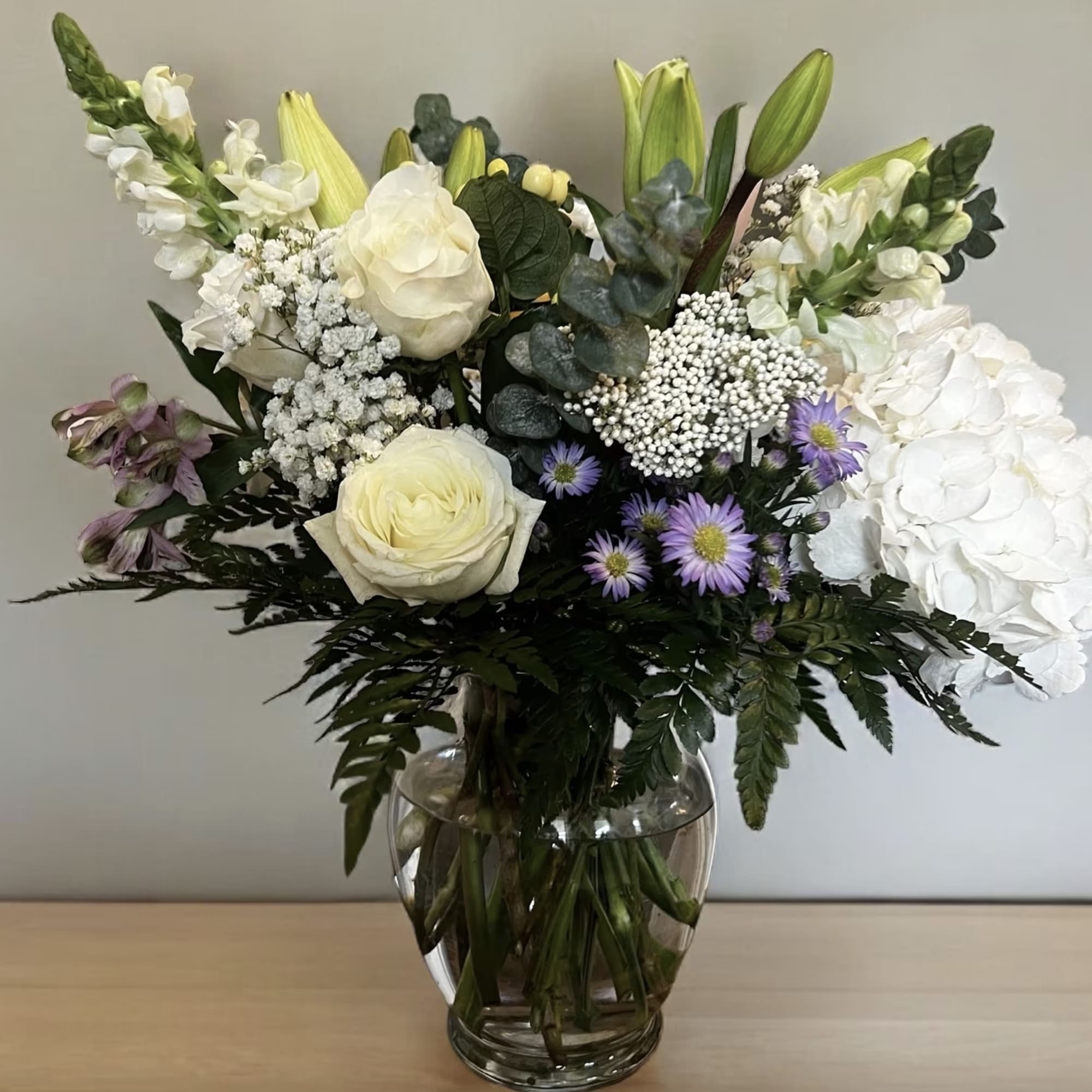 A tender expression of care, this soft and timeless arrangement is designed