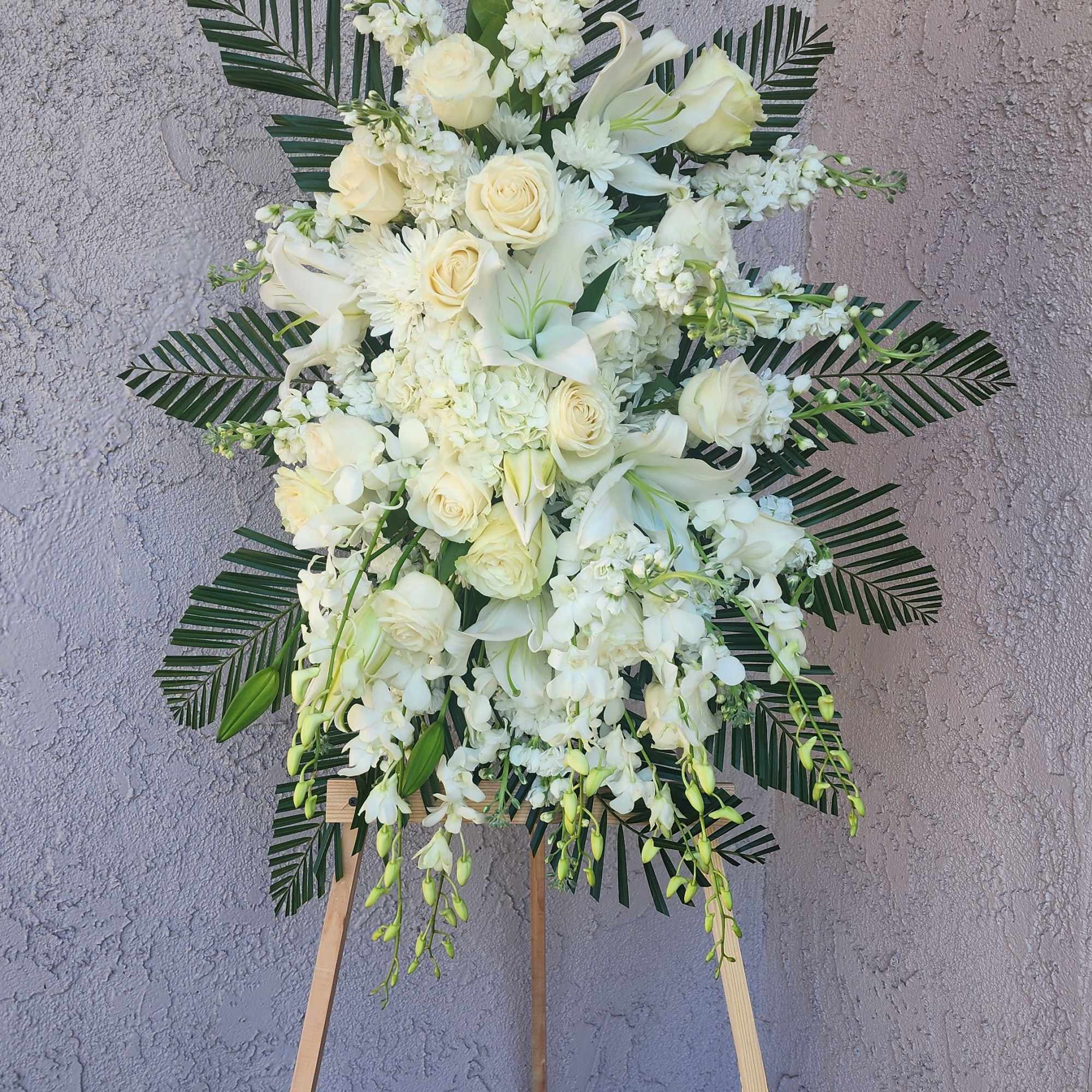 An all white tribute, this funeral spray is pure and tranquil. Featuring