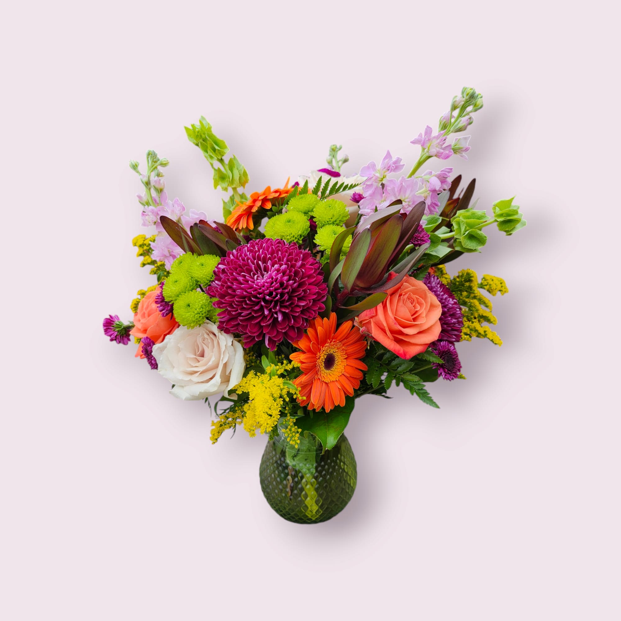 Fall colors of various flowers for this full all around vase bouquet.