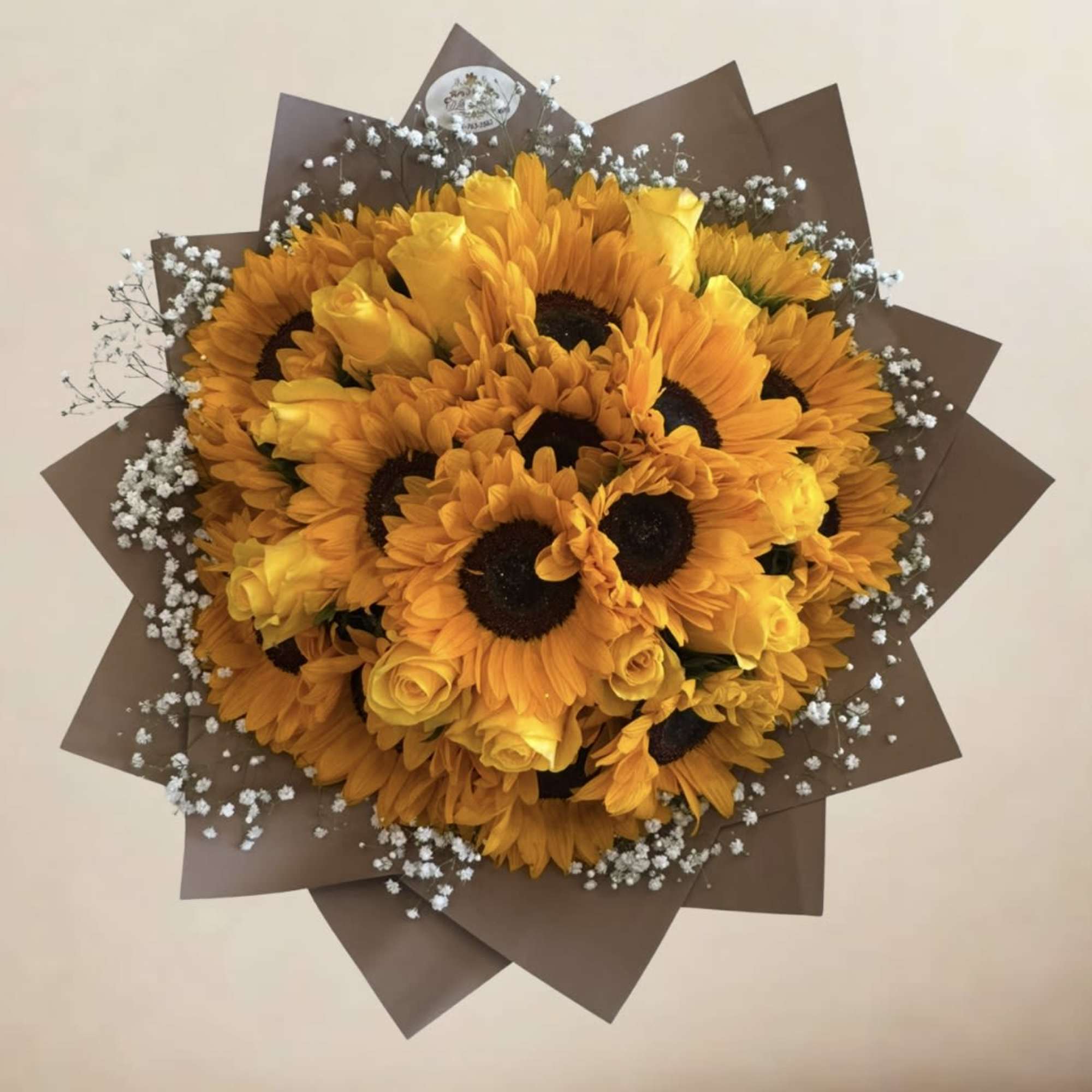 A beautiful bouquet made of yellow roses and stunning sunflowers perfectly put