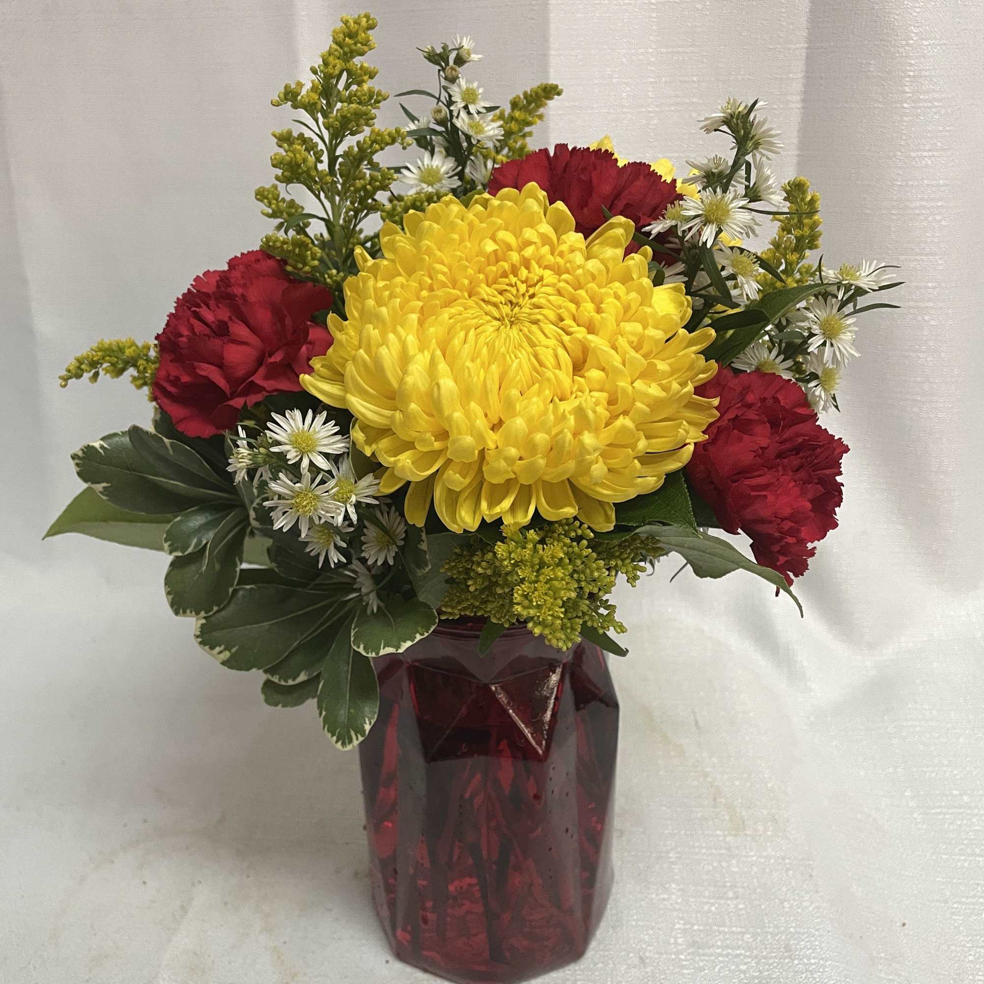 Send some cheer with a beautiful arrangement of bright yellow chrysanthemums, red