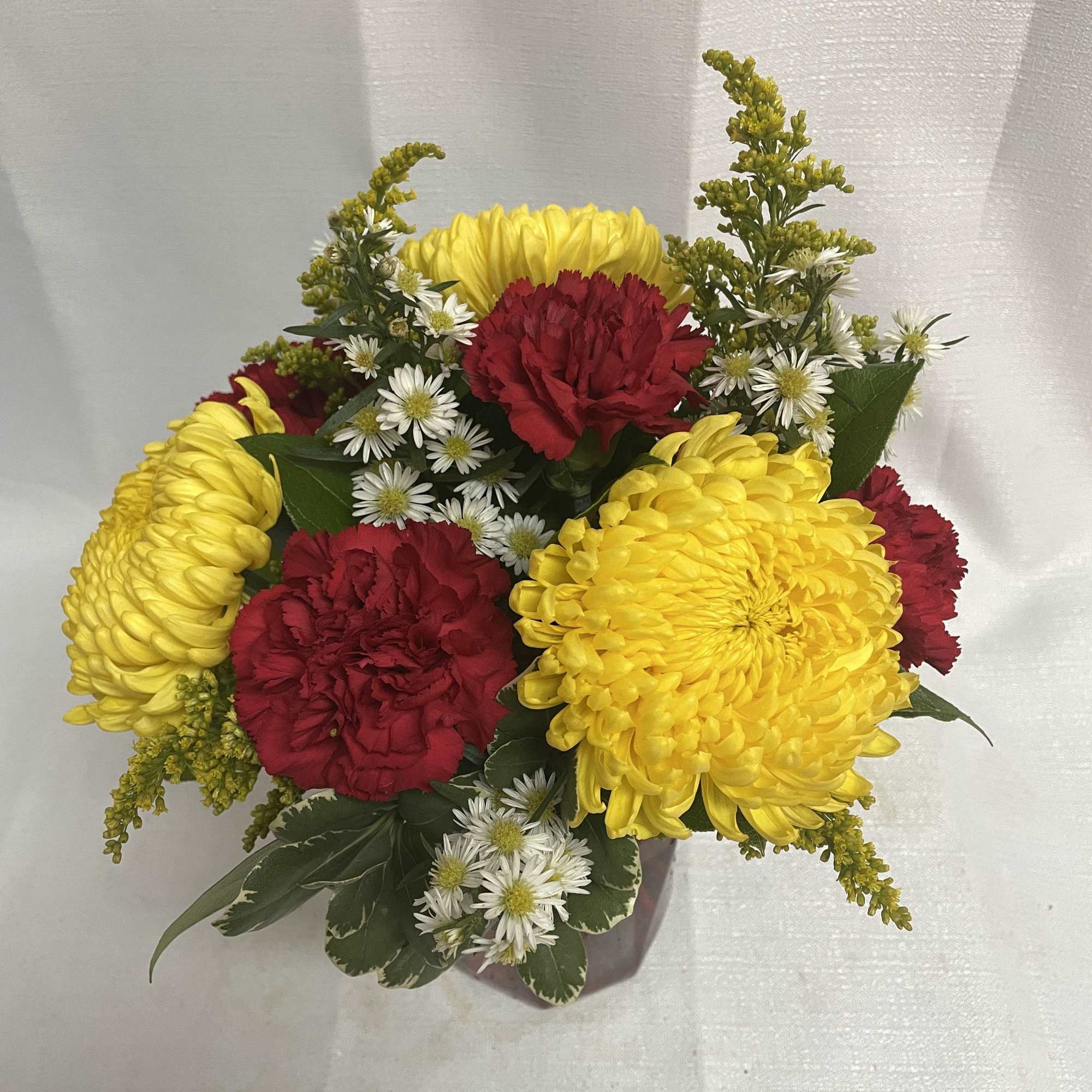 Send some cheer with a beautiful arrangement of bright yellow chrysanthemums, red