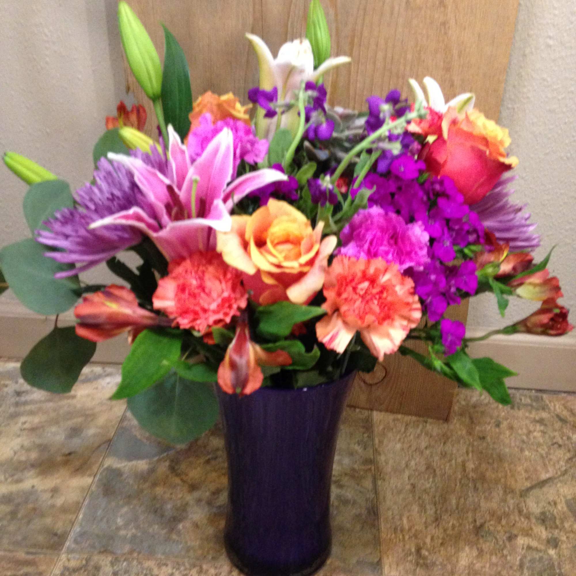 Lillies ,Roses, Alstro. Seasonal, Flowers in a clear vase.