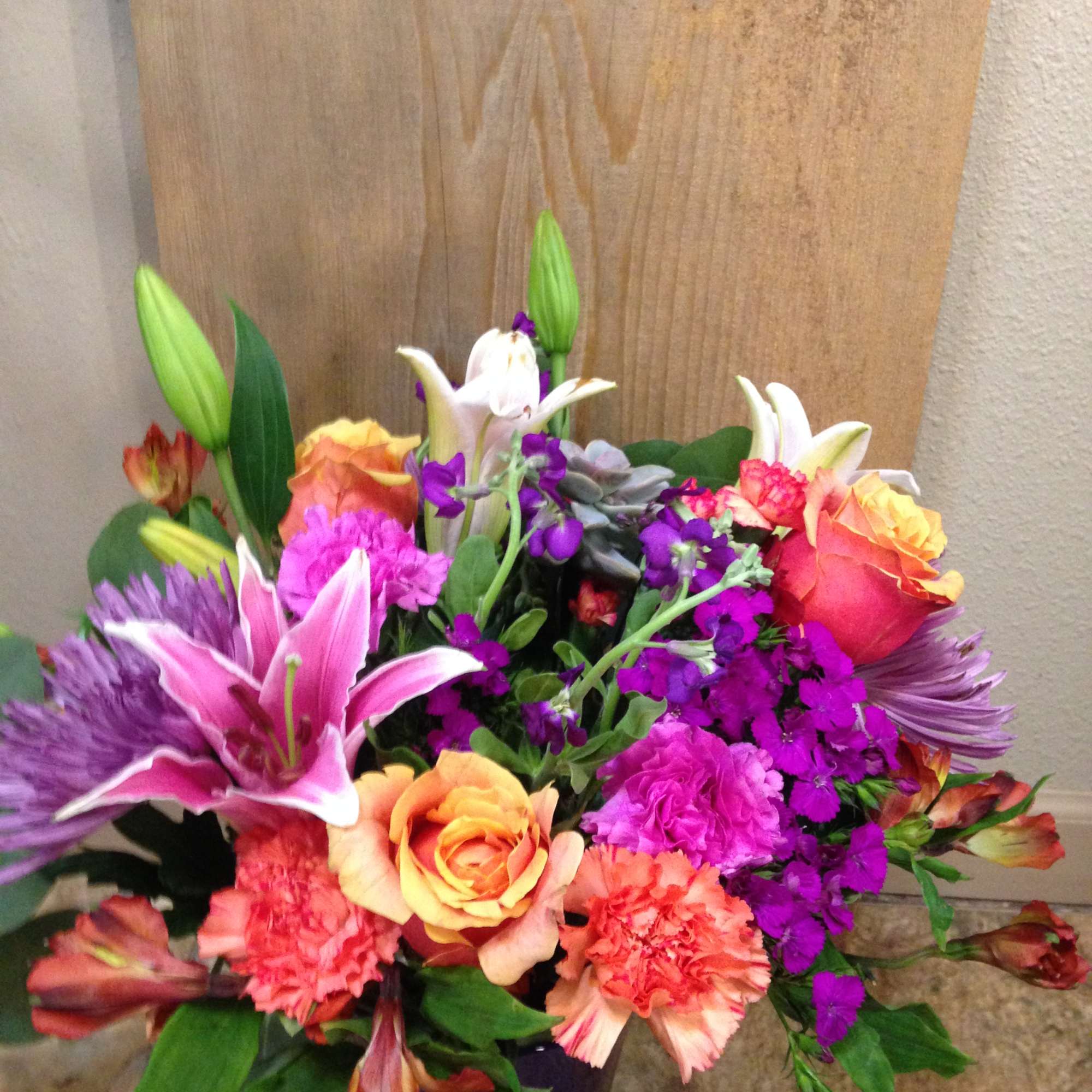 Lillies ,Roses, Alstro. Seasonal, Flowers in a clear vase.