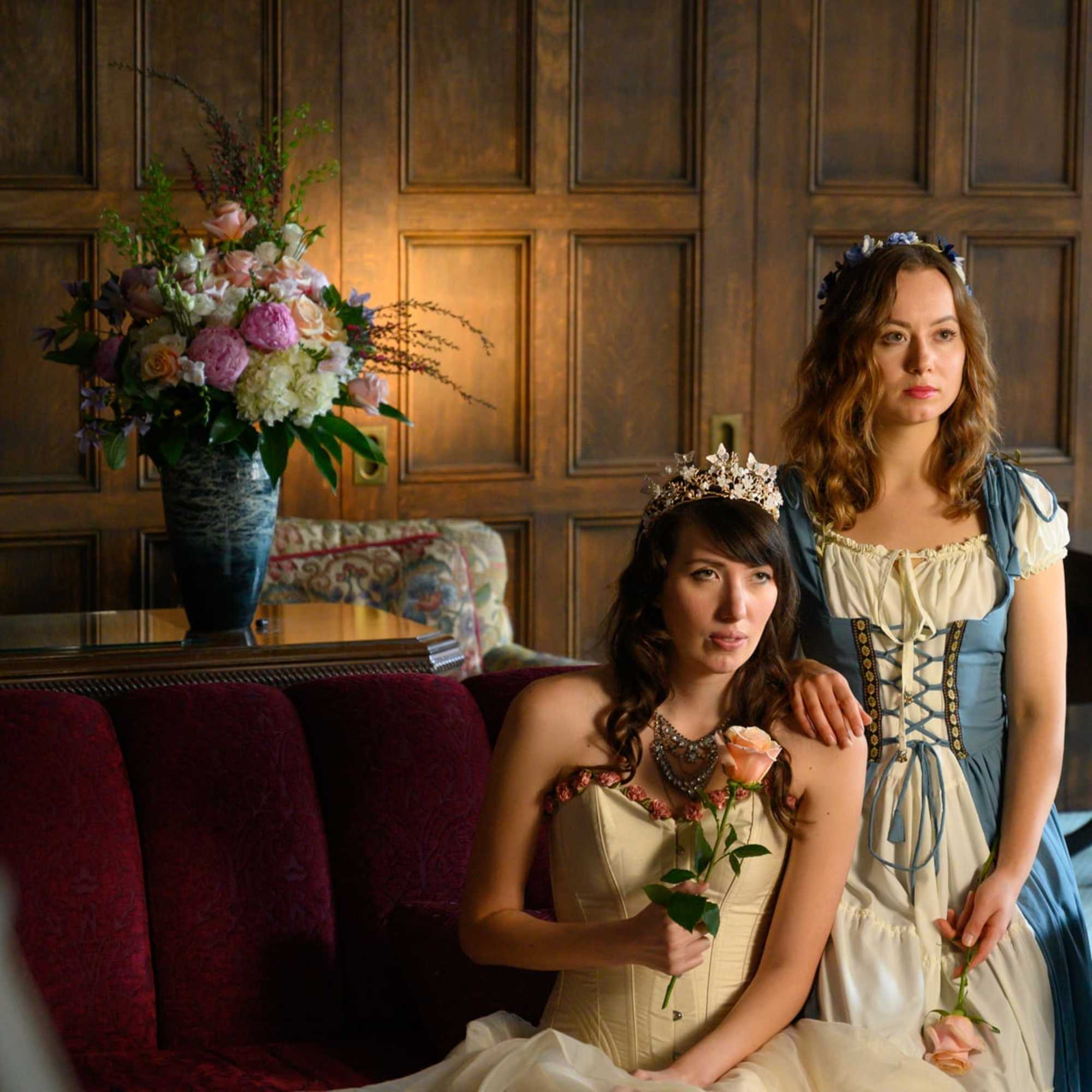 Elegant, tall floral arrangement in a glazed vase. 