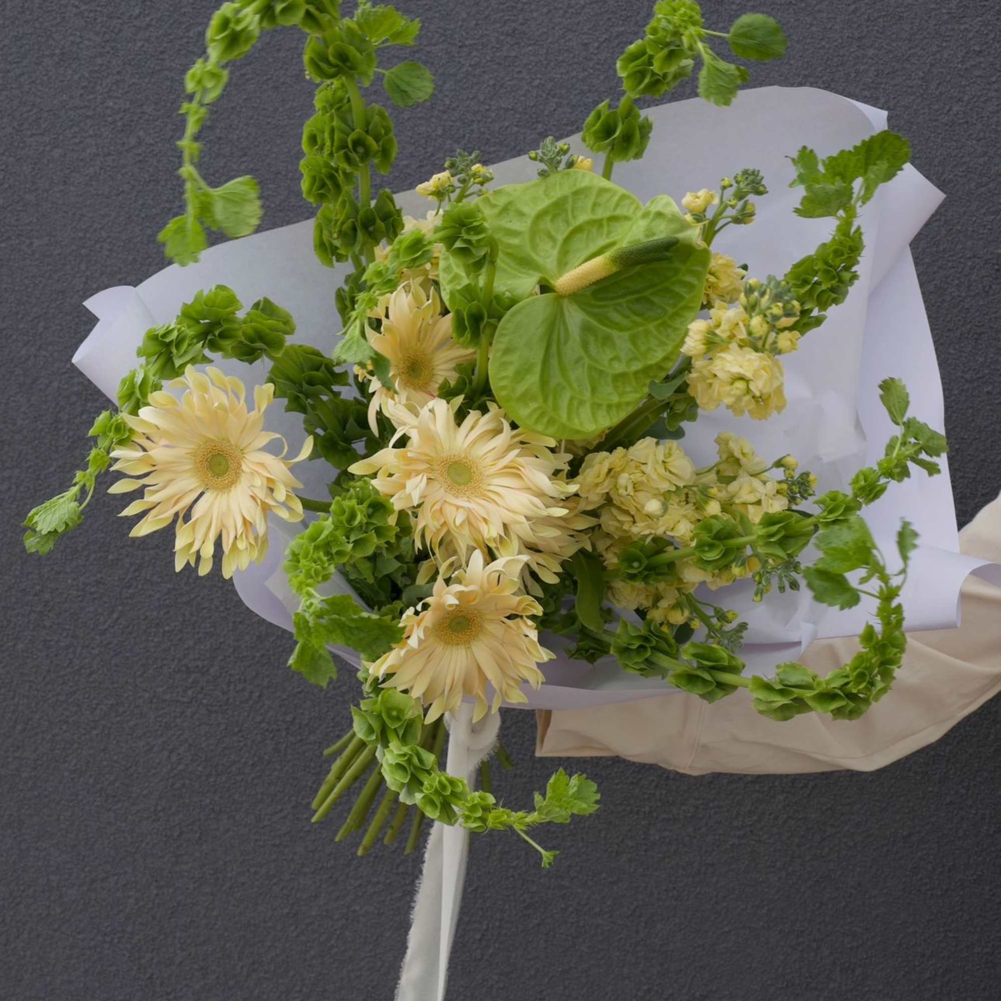 A fresh and modern bouquet in a soft lime-green palette. Featuring playful