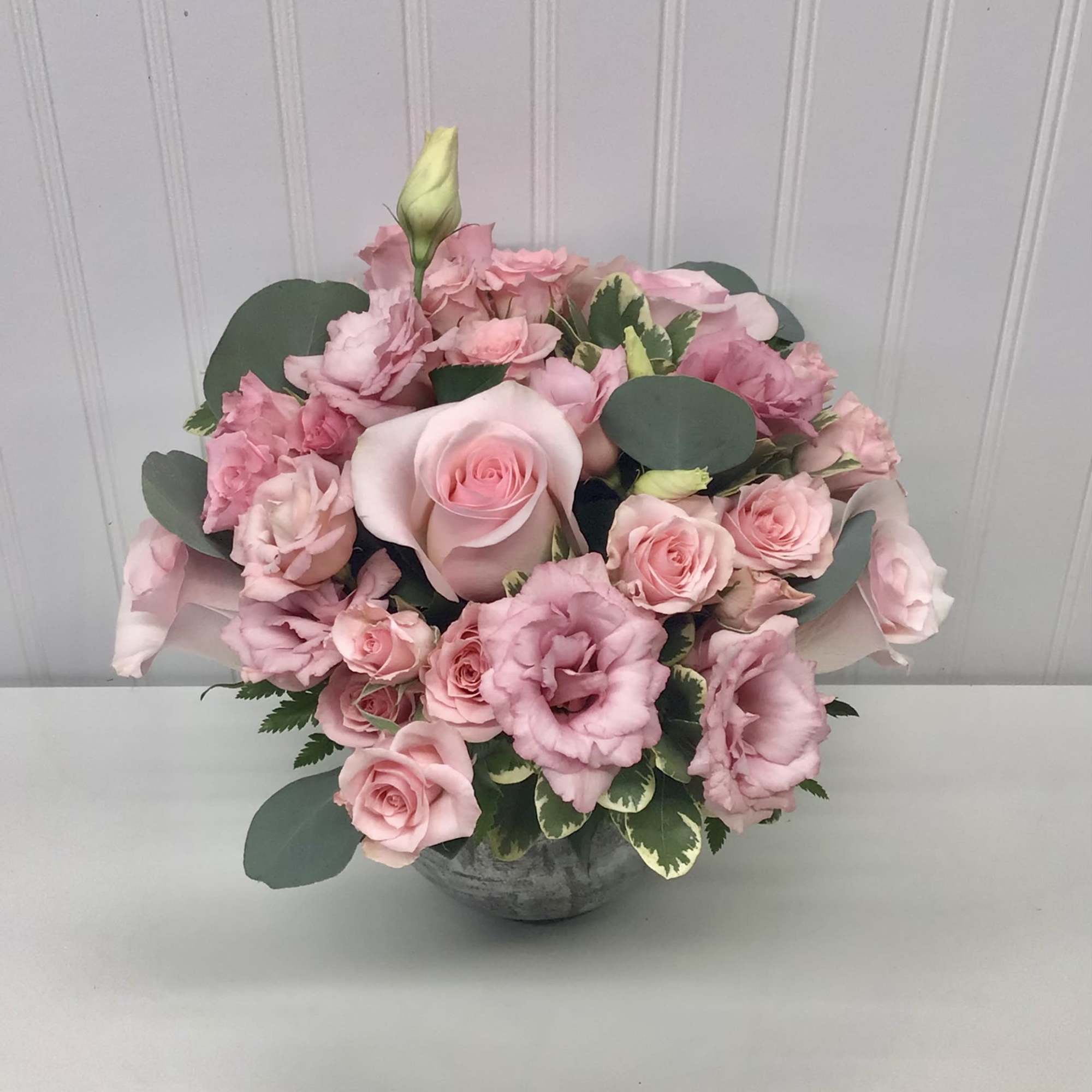 A beautiful flower arrangement with pink roses, pink spray roses and pink