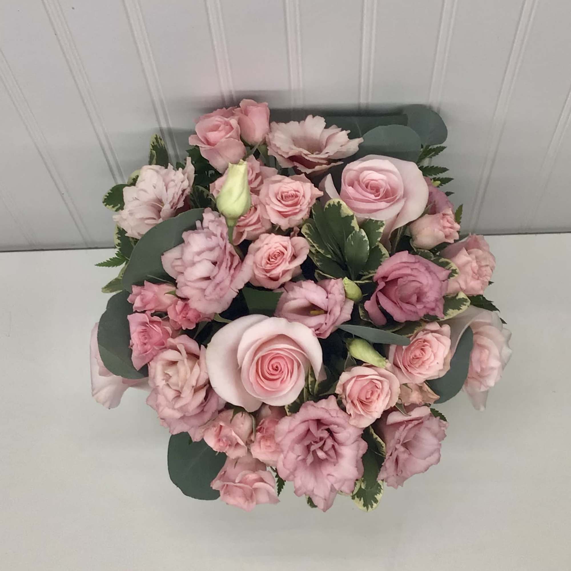 A beautiful flower arrangement with pink roses, pink spray roses and pink