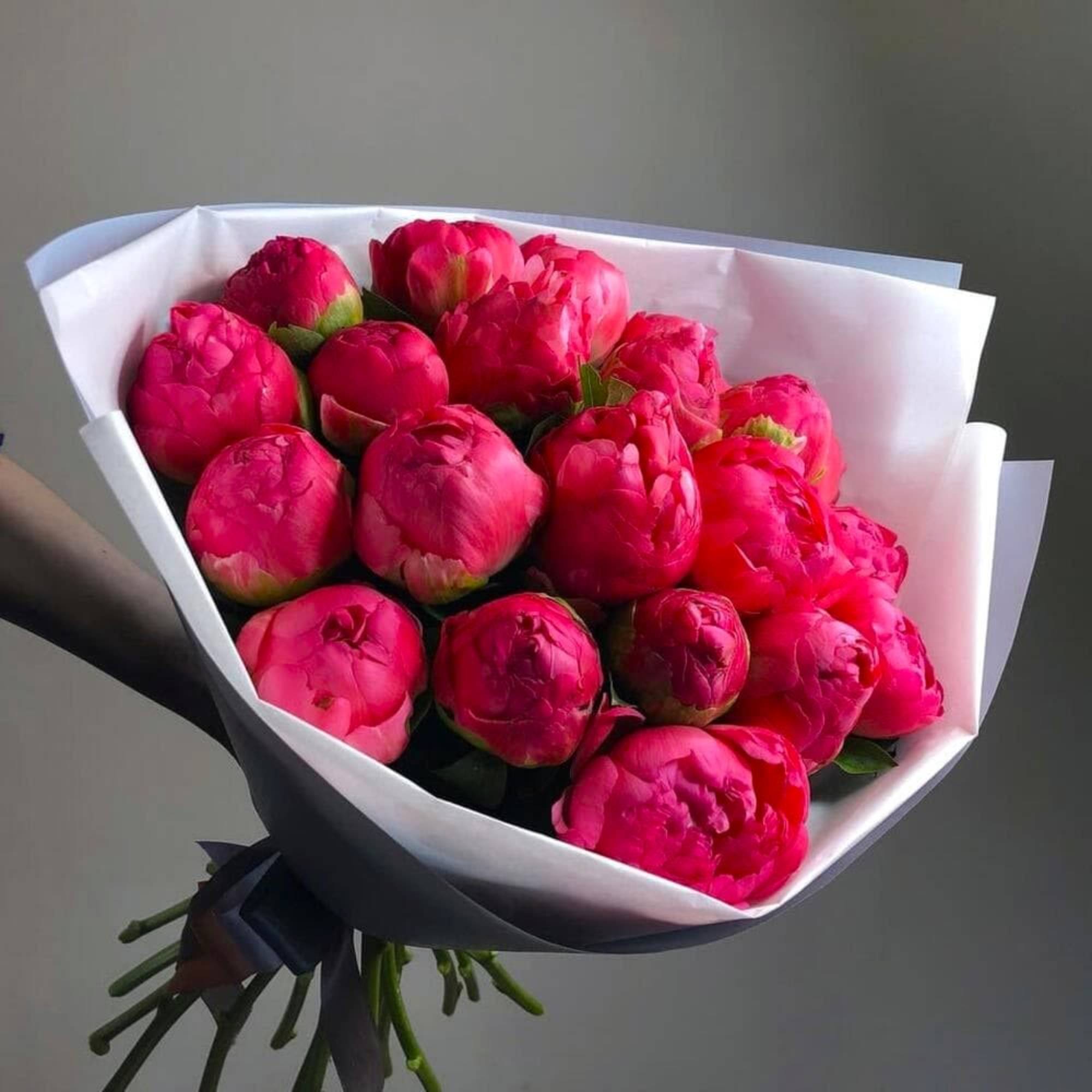 A lush bouquet of elegant peonies, celebrated for their full, delicate petals