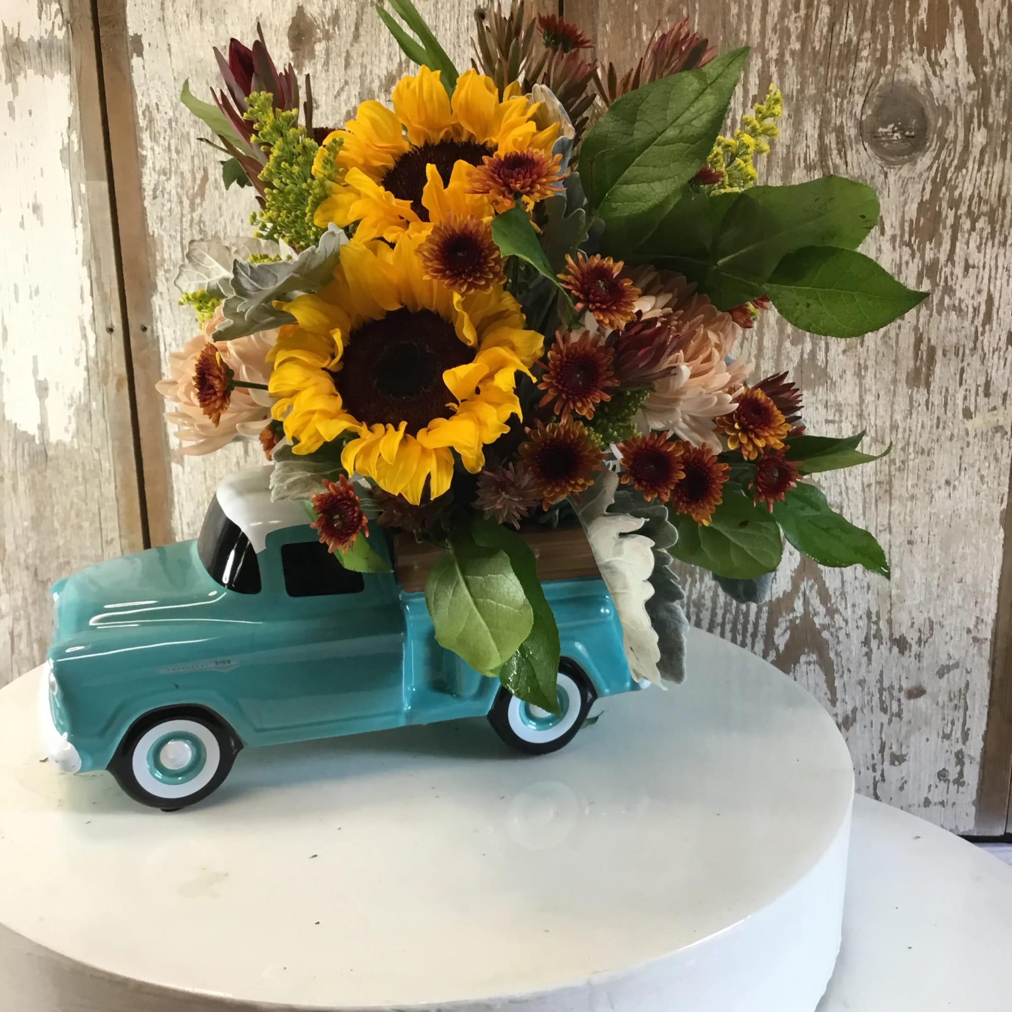 Fall arrangement in blue truck. Buy it this fall and come back