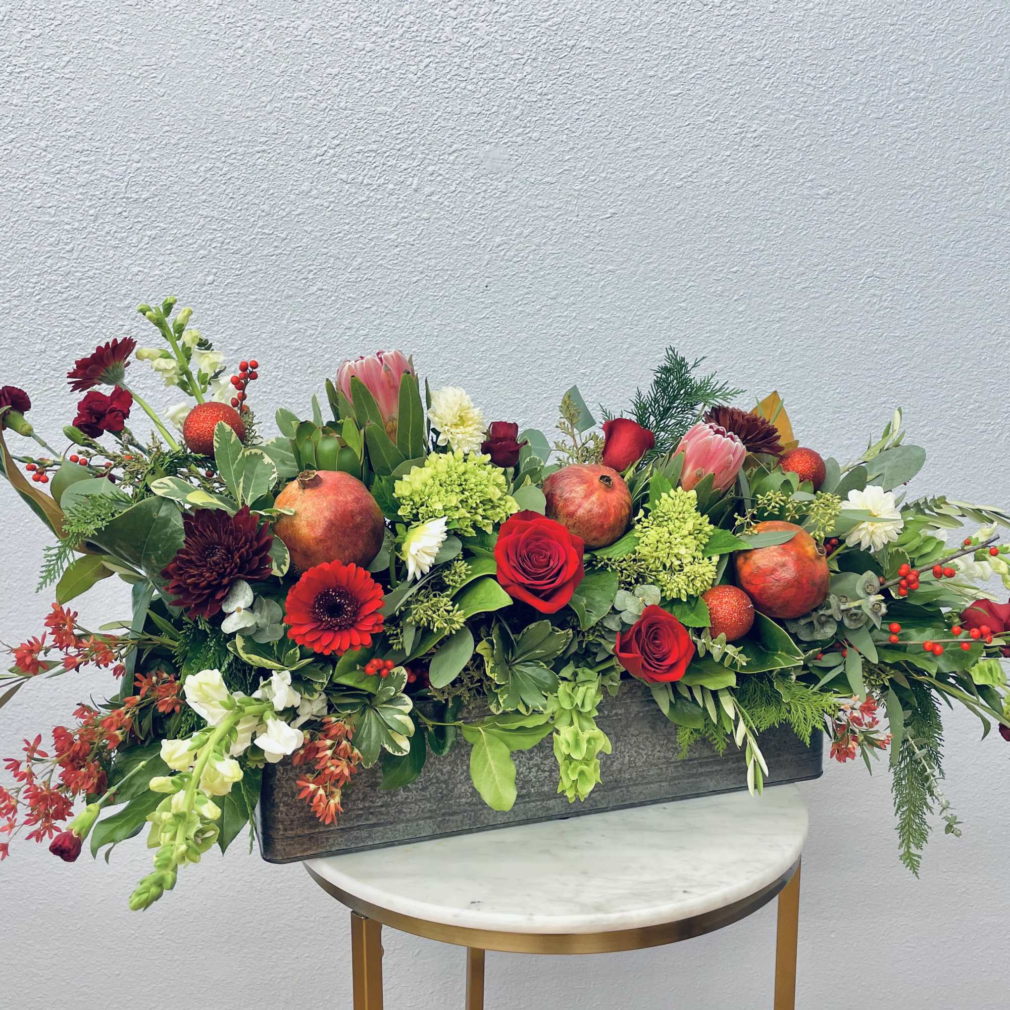 Striking and fun!  This holiday box boasts gorgeous protea, pomegranate, sparkly