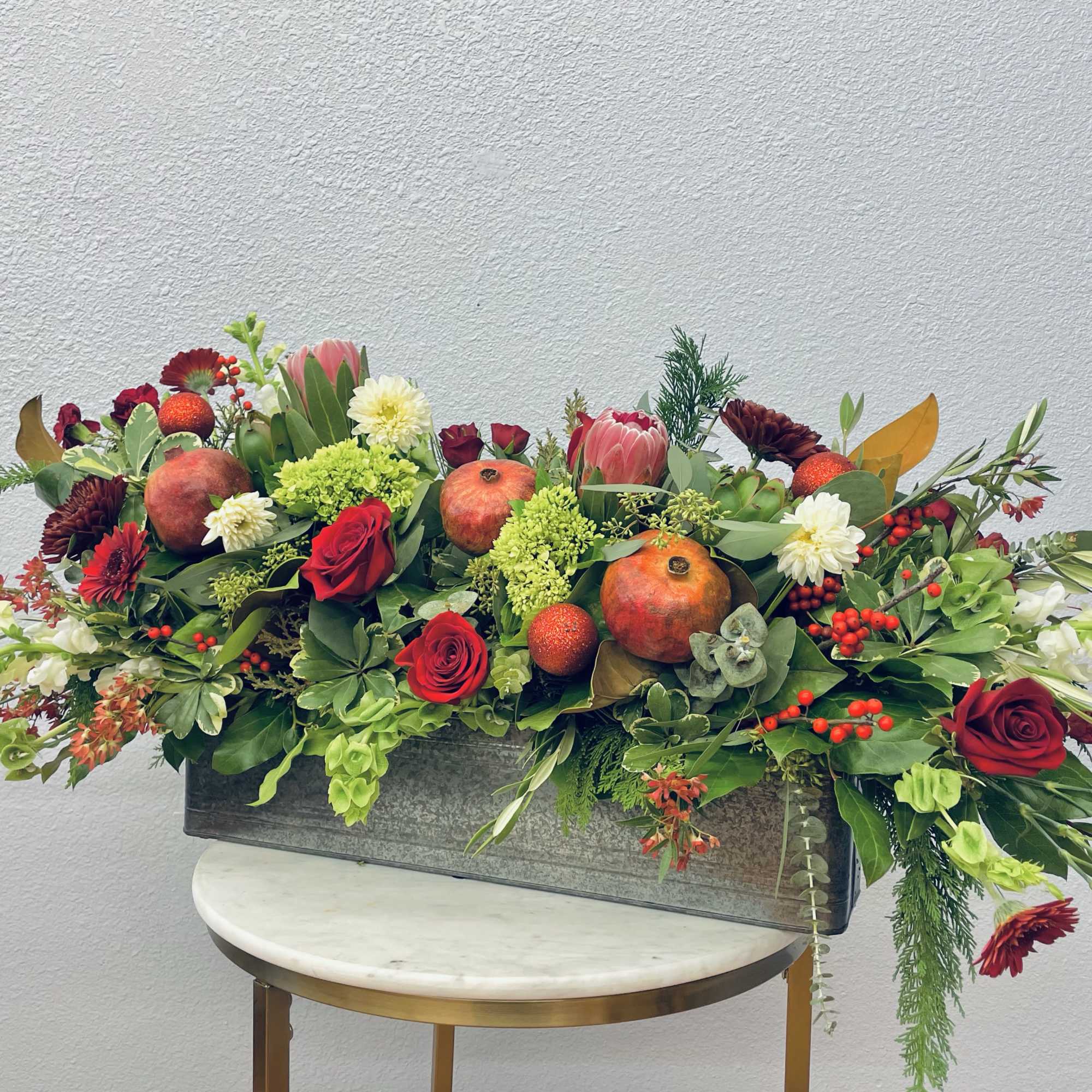 Striking and fun!  This holiday box boasts gorgeous protea, pomegranate, sparkly