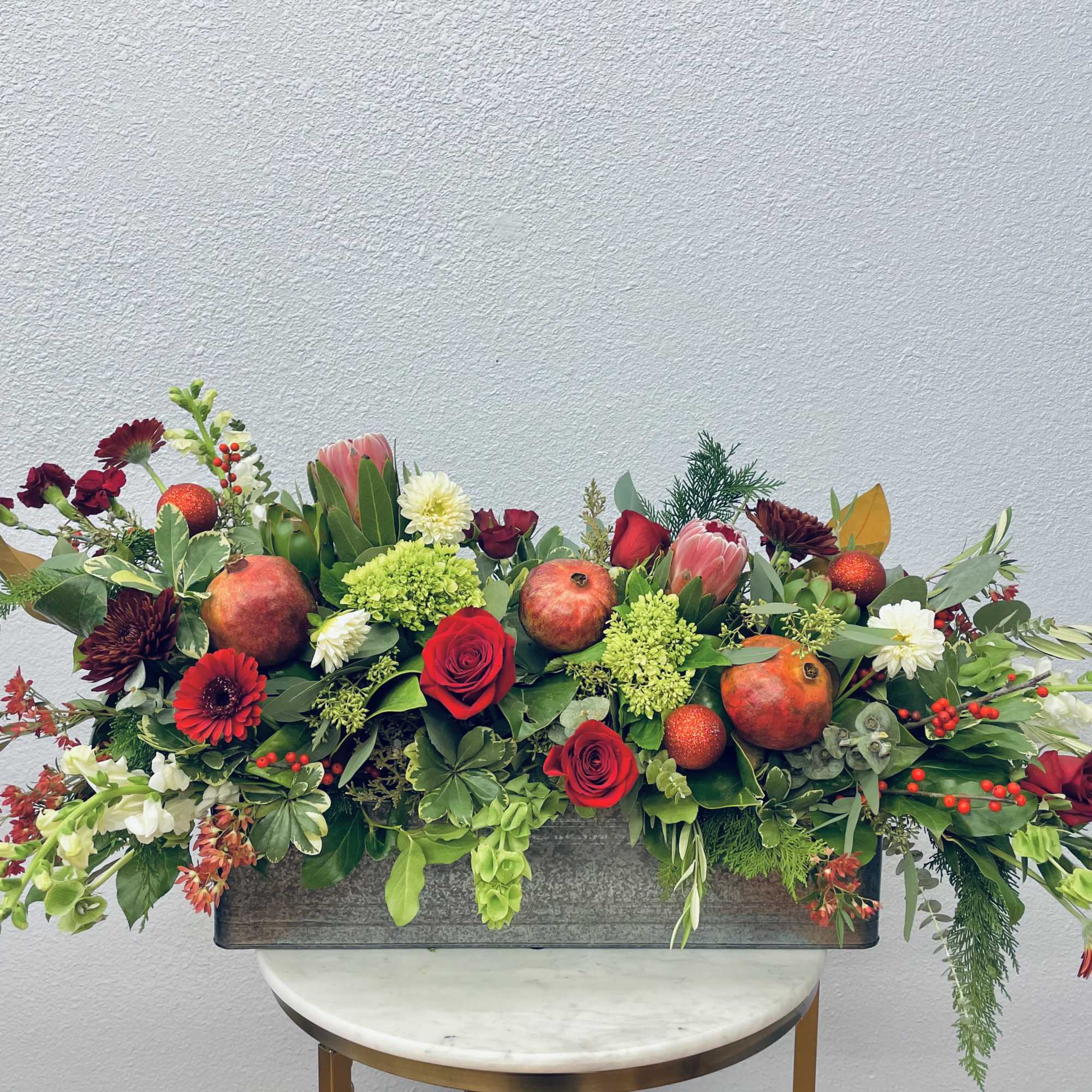 Striking and fun!  This holiday box boasts gorgeous protea, pomegranate, sparkly