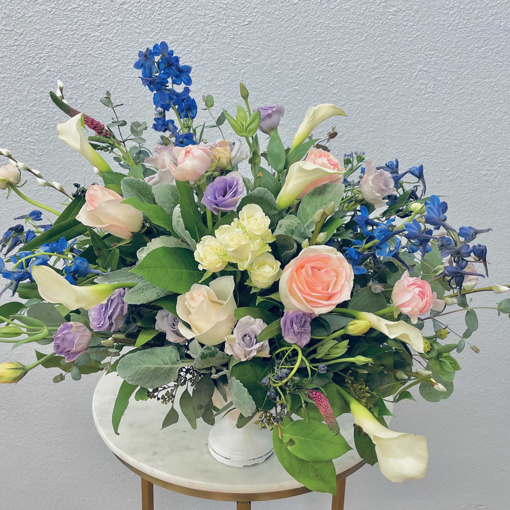 Soft spring hues of cream, blush, blue and white tucked into botanical