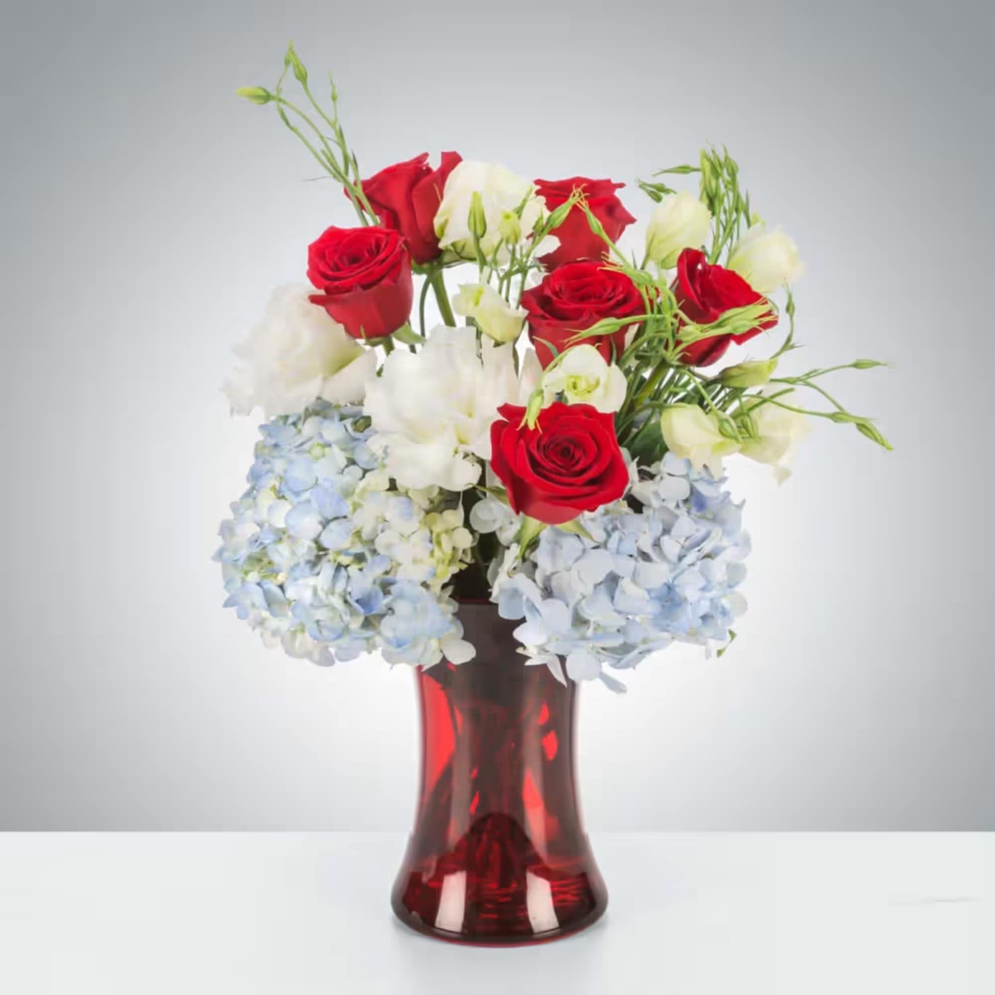 Celebrate America with this red, white, and blue arrangement. Perfect for sending