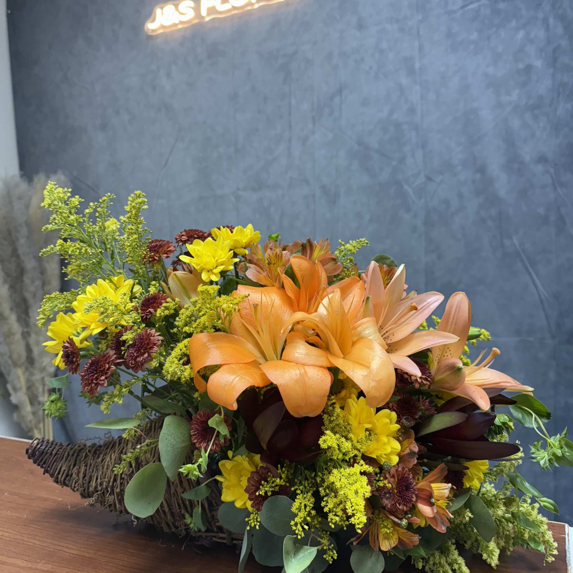 Introducing our Cornucopia of Fall—a stunning arrangement featuring vibrant orange lilies, daisies Introducing our Cornucopia of Fall—a stunning arrangement featuring vibrant orange lilies, daisies