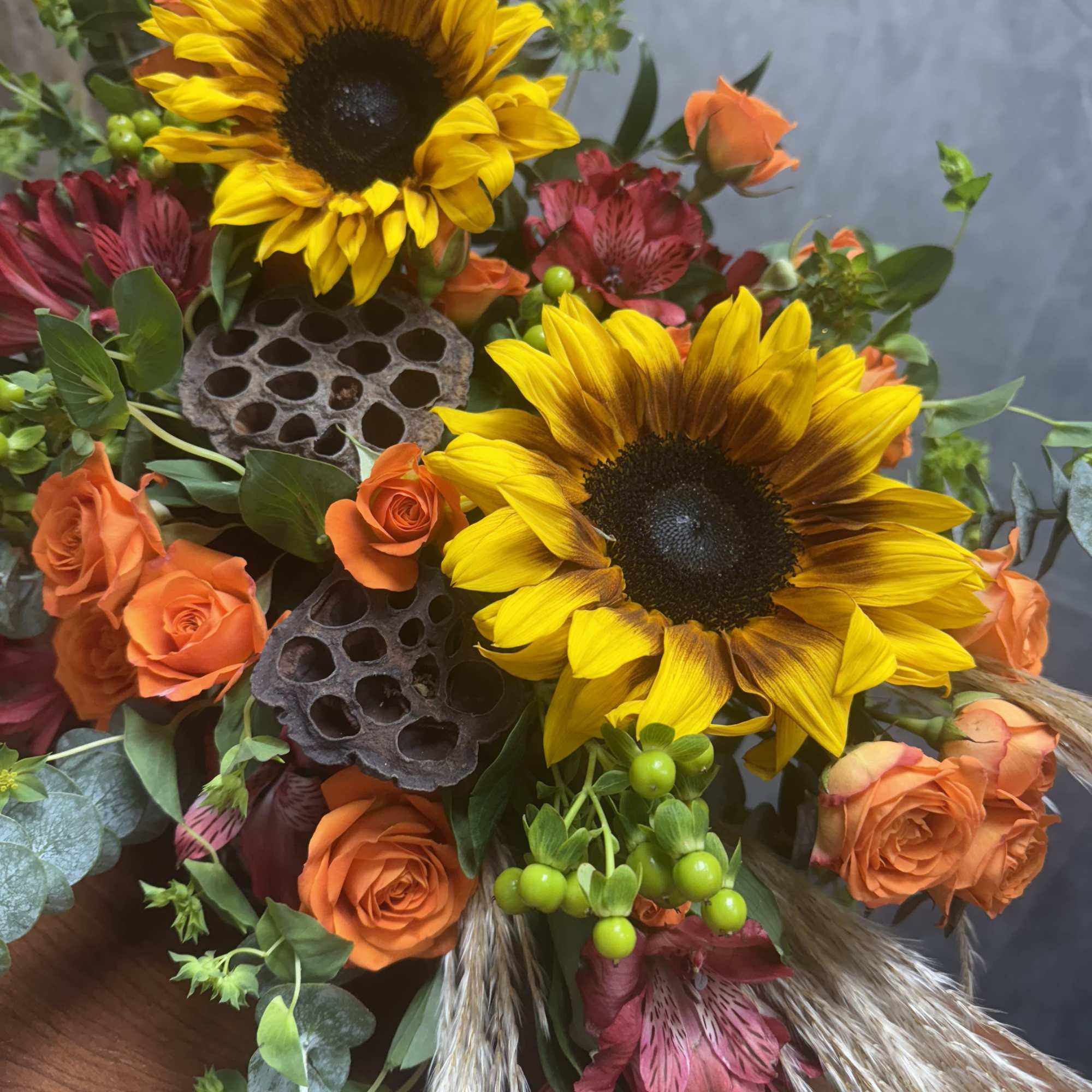 Introducing our Harvest Cornucopia a stunning arrangement featuring vibrant sunflowers and unique Introducing our Harvest Cornucopia a stunning arrangement featuring vibrant sunflowers and unique