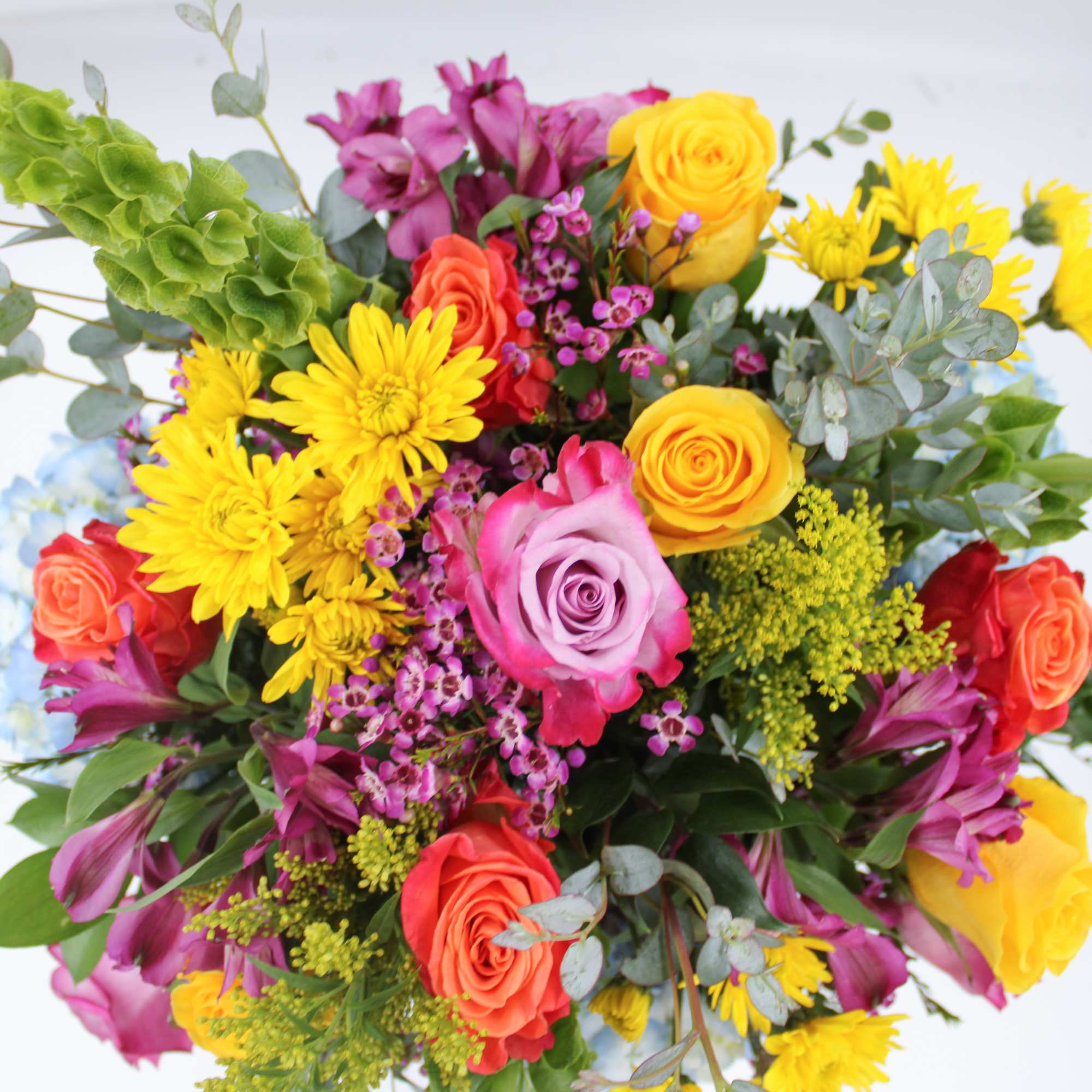 Carnival is a bright and cheery mix of Blue Hydrangea, Purple Alstromeria