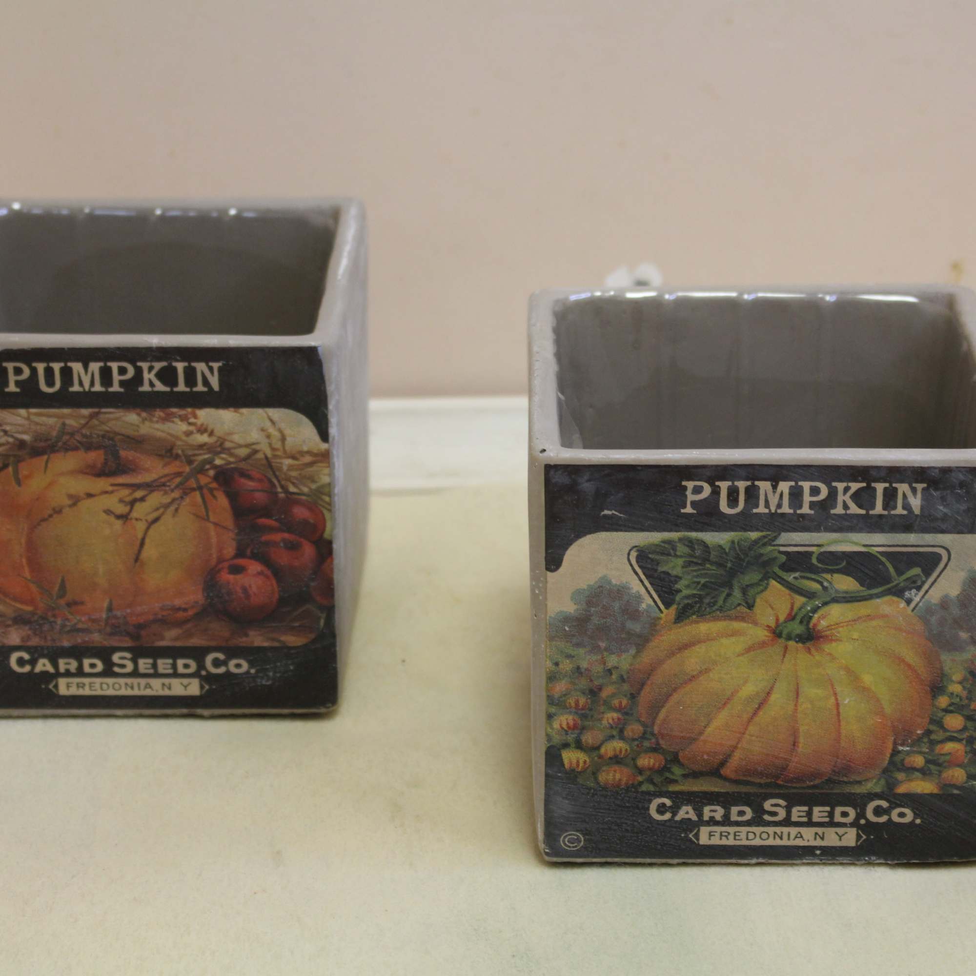 a distressed pumpkin scene set on a cement cube filled with a a distressed pumpkin scene set on a cement cube filled with a