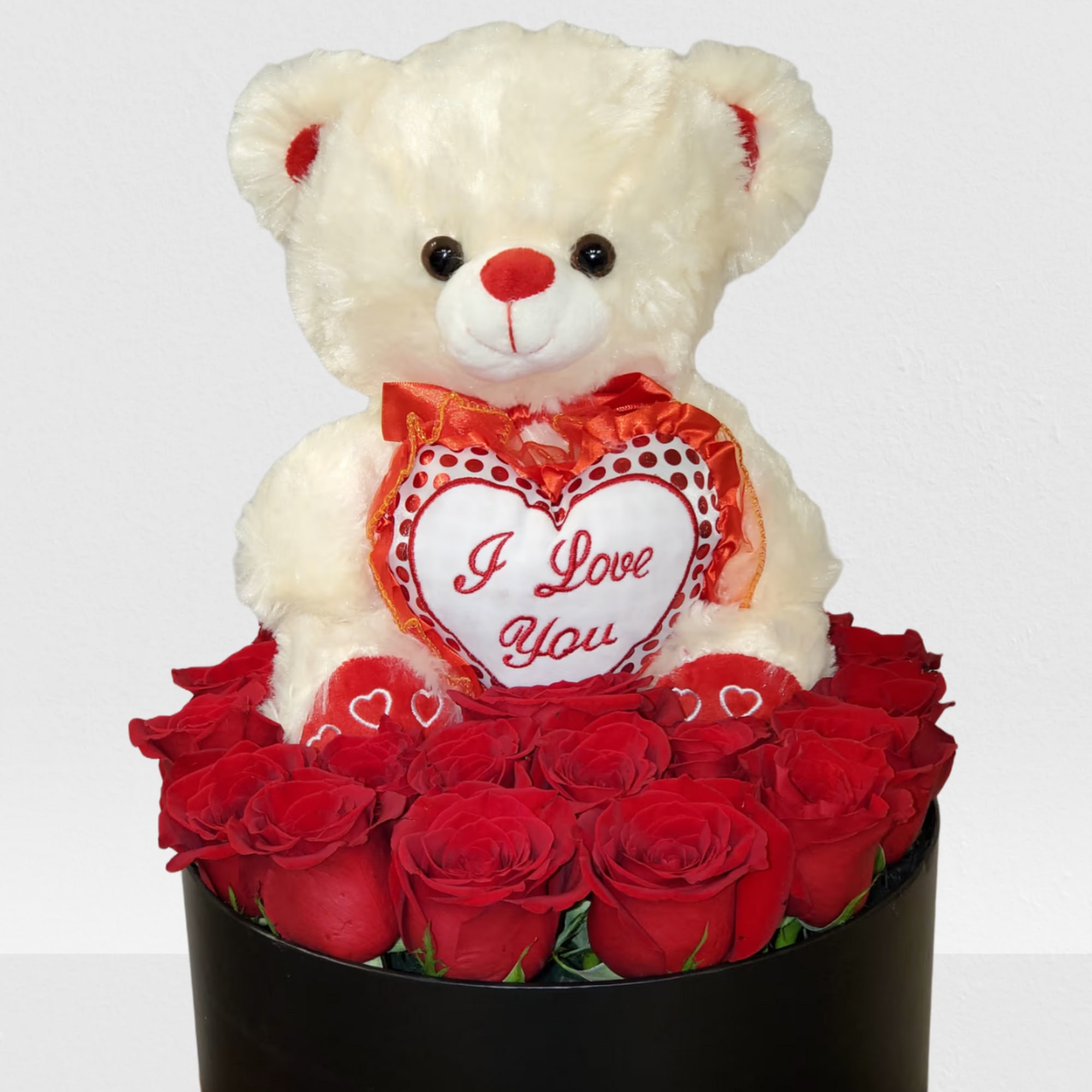 Teddy bear surrounded by roses in a box 
NOTICE BOX MAY BE