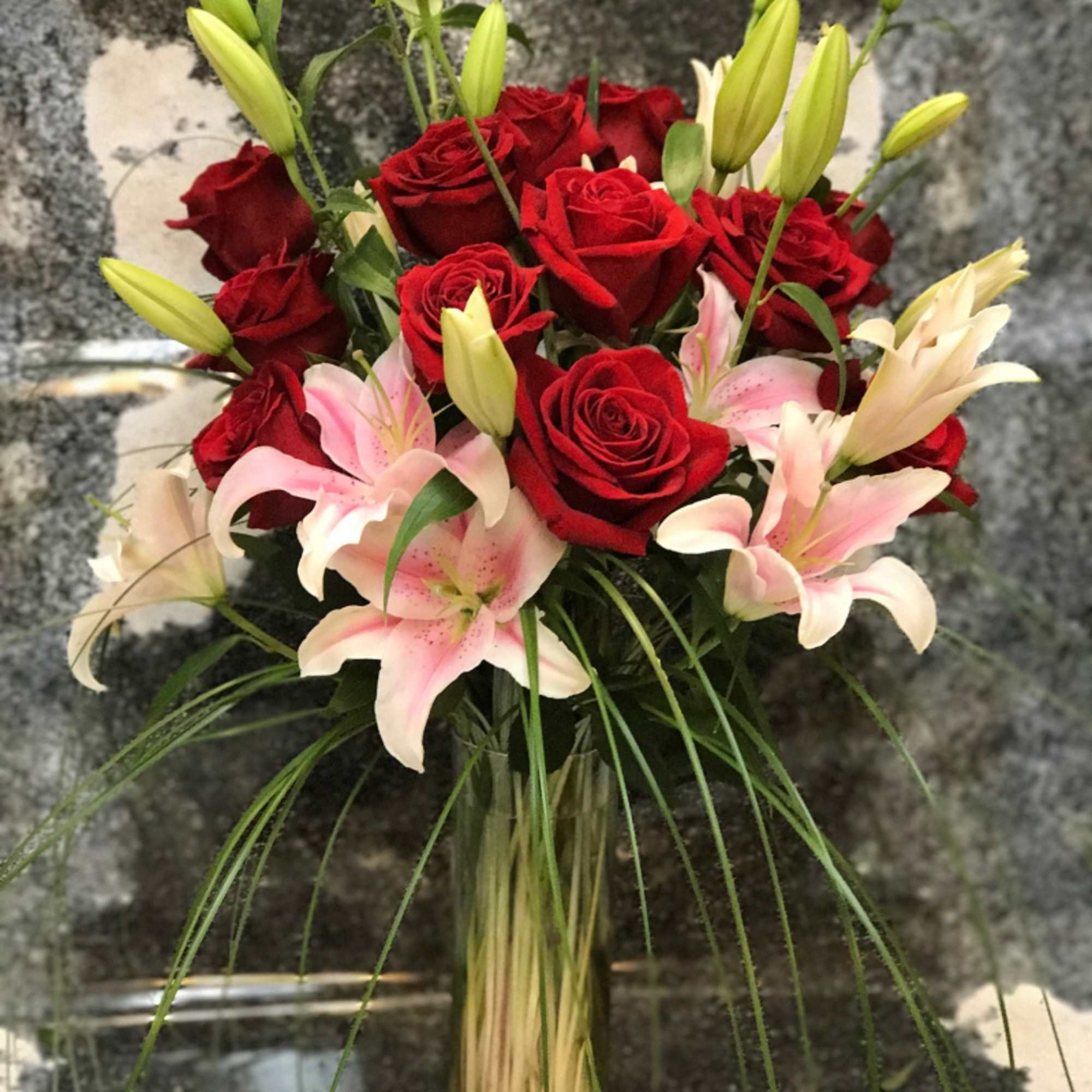 Simple and Tall design arranged with Pink Lilies, one dozen Red Roses Simple and Tall design arranged with Pink Lilies, one dozen Red Roses