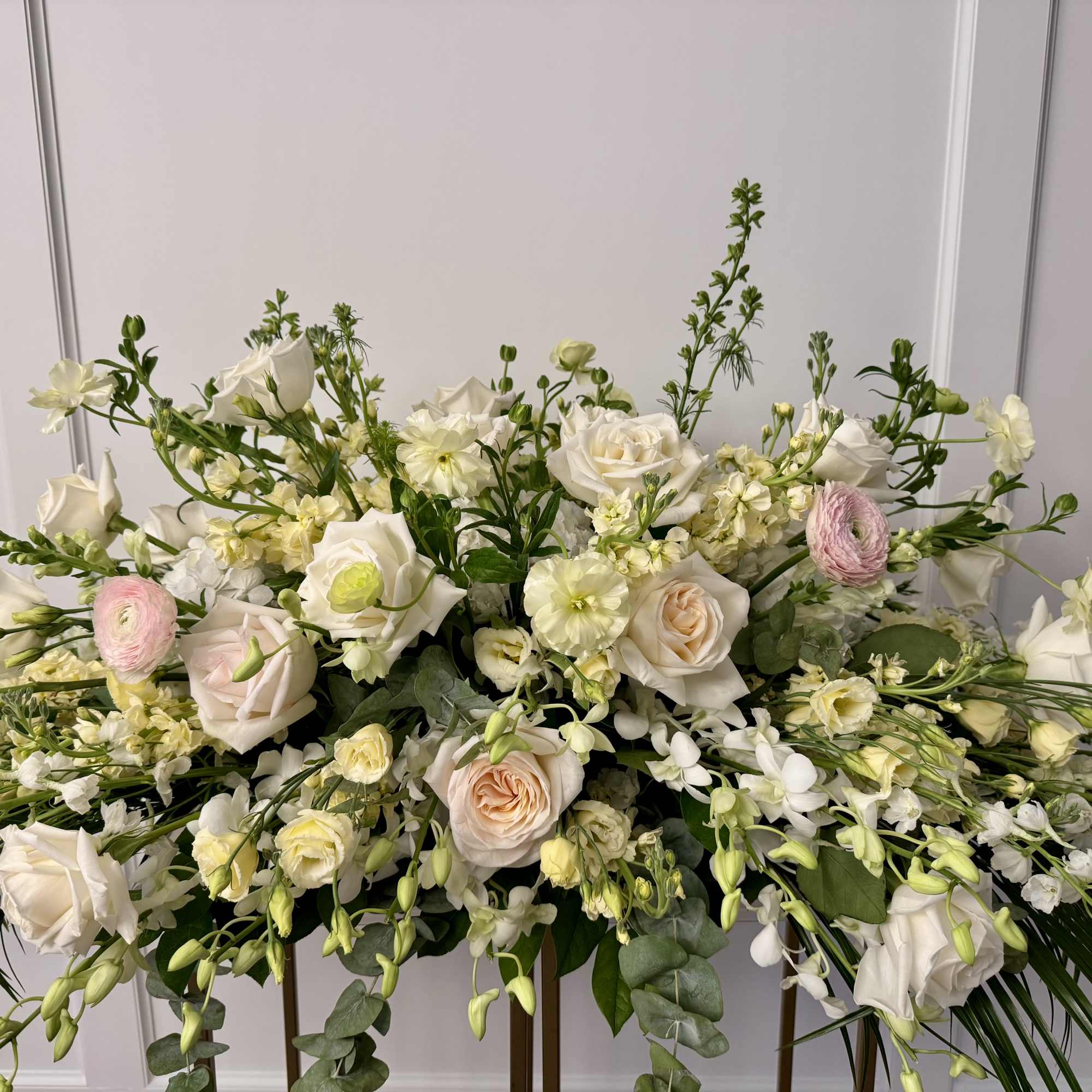 A large casket spray made with premium flower selections in a neutral