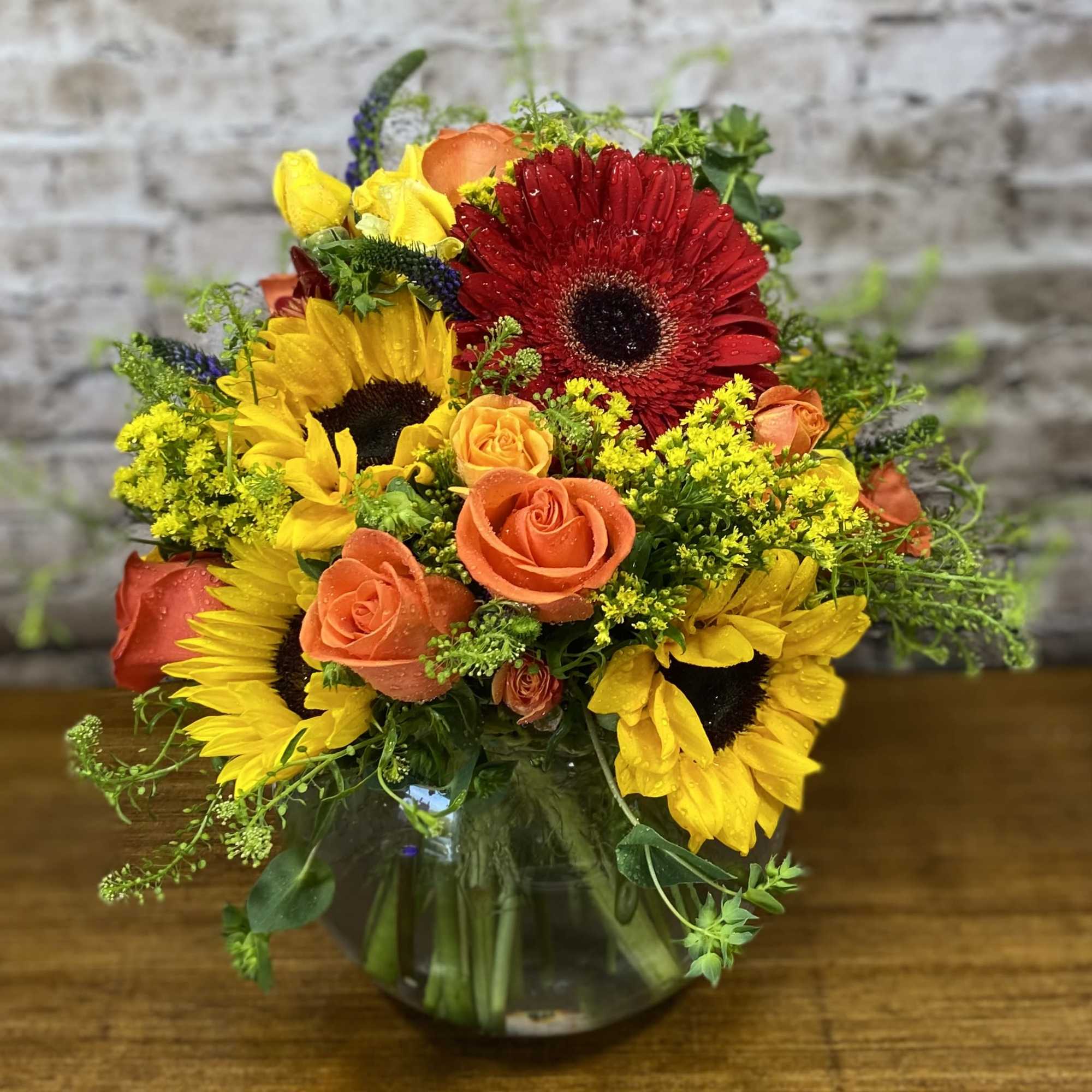 An beautiful mix of sunflowers, roses, and gerbera daisies with accent flowers An beautiful mix of sunflowers, roses, and gerbera daisies with accent flowers