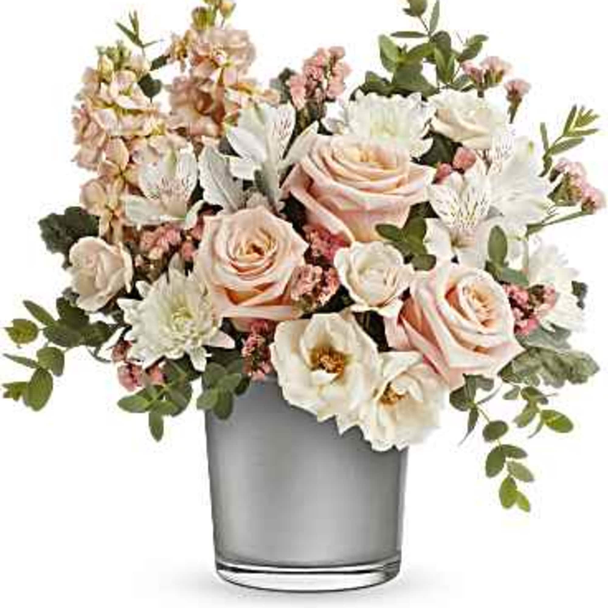 Radiating peace and energy, this unforgettable arrangement of soft peach and cr&egrave;me