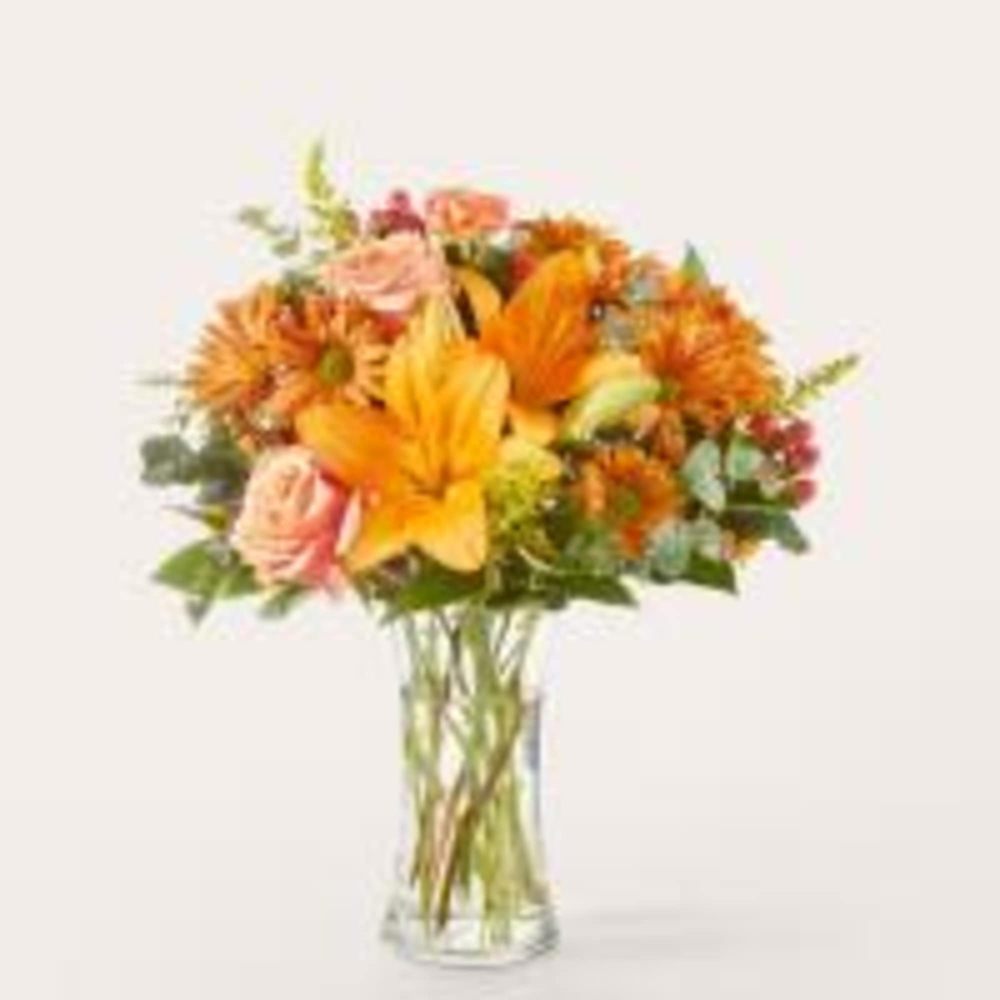 Spark joy with the colors of fall in this warm arrangement, a
