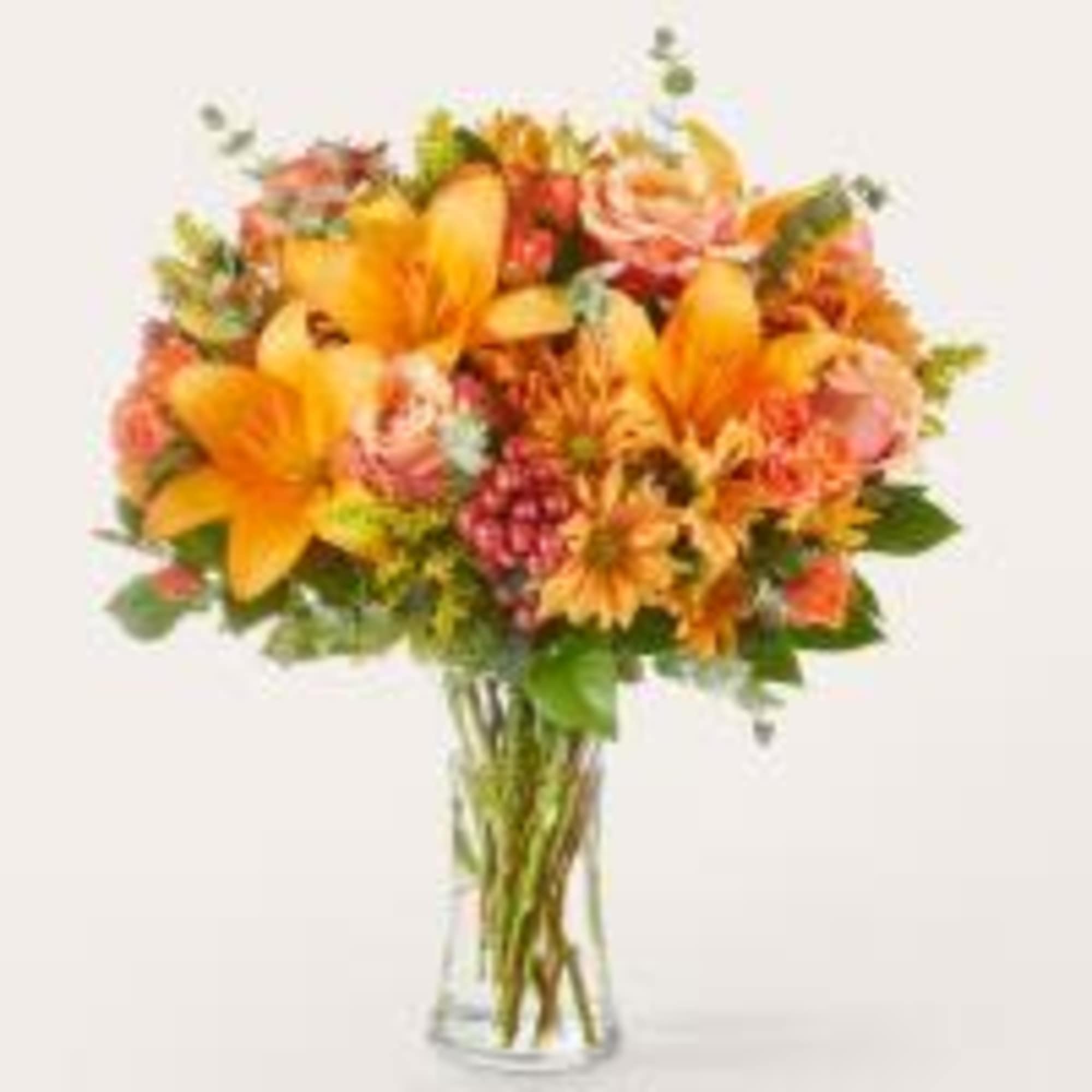 Spark joy with the colors of fall in this warm arrangement, a