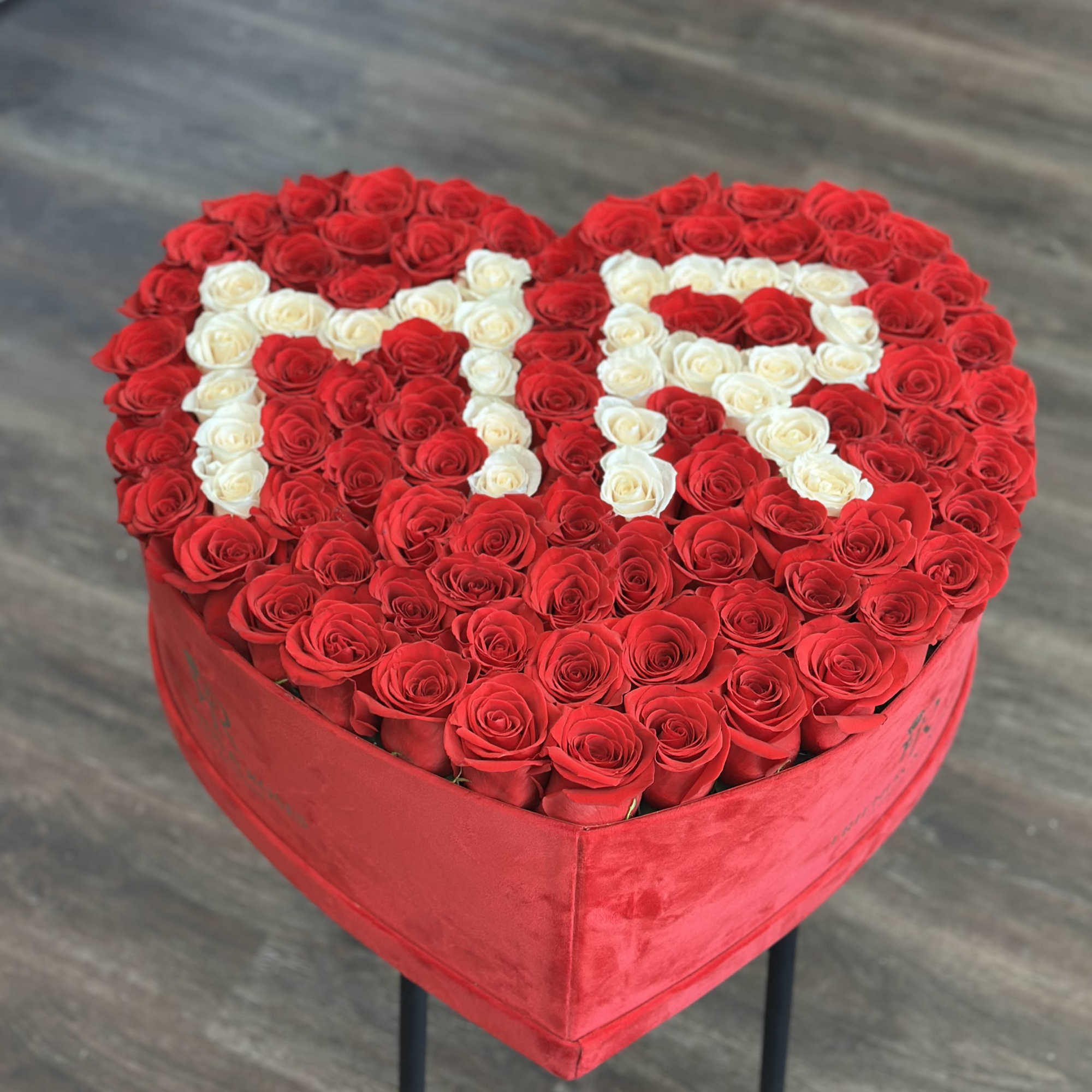 Our heart-shaped box arrangement with 125 fresh roses is a work of