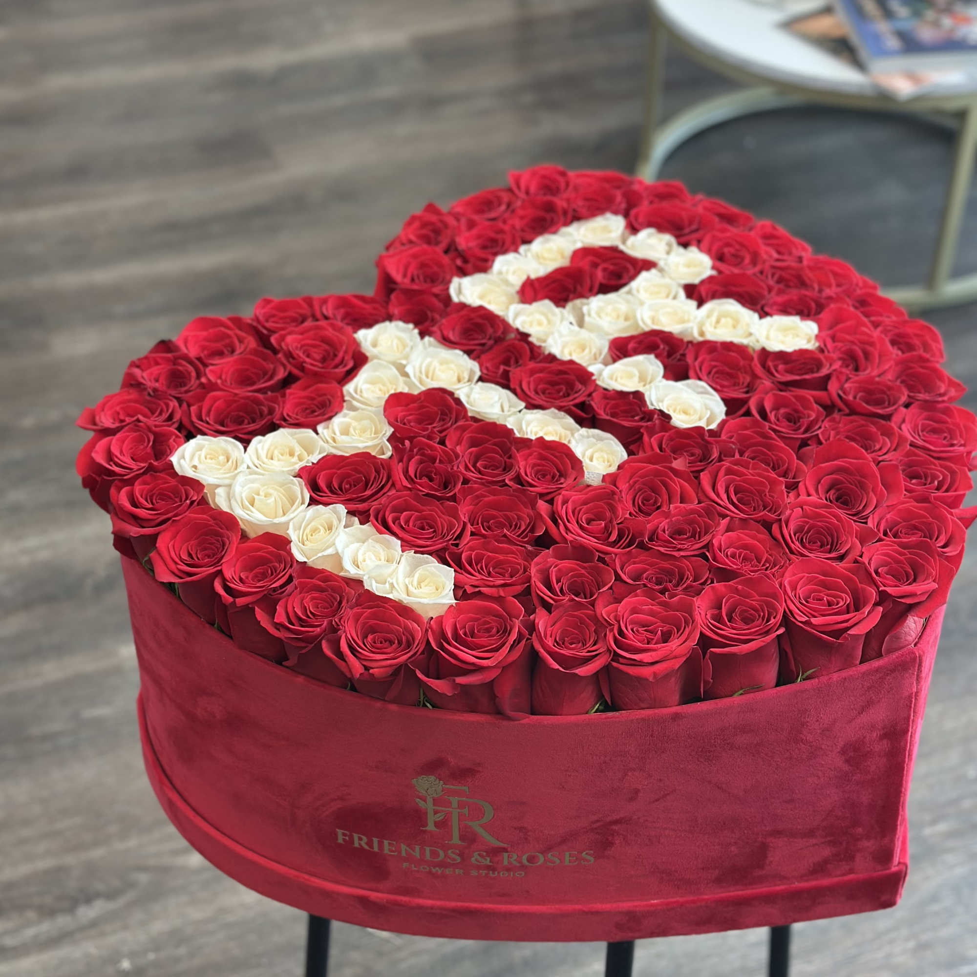 Our heart-shaped box arrangement with 125 fresh roses is a work of