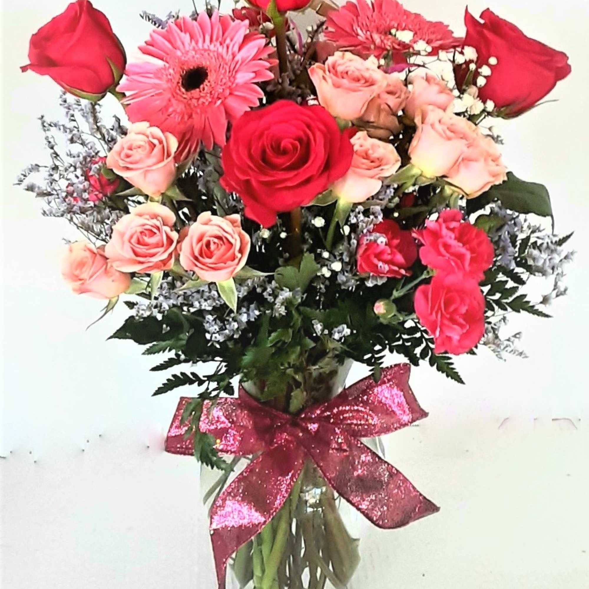 Beautiful roses,gerbera daisies, spray roses,mini carnations, with feminine fillers and greenery,accented by