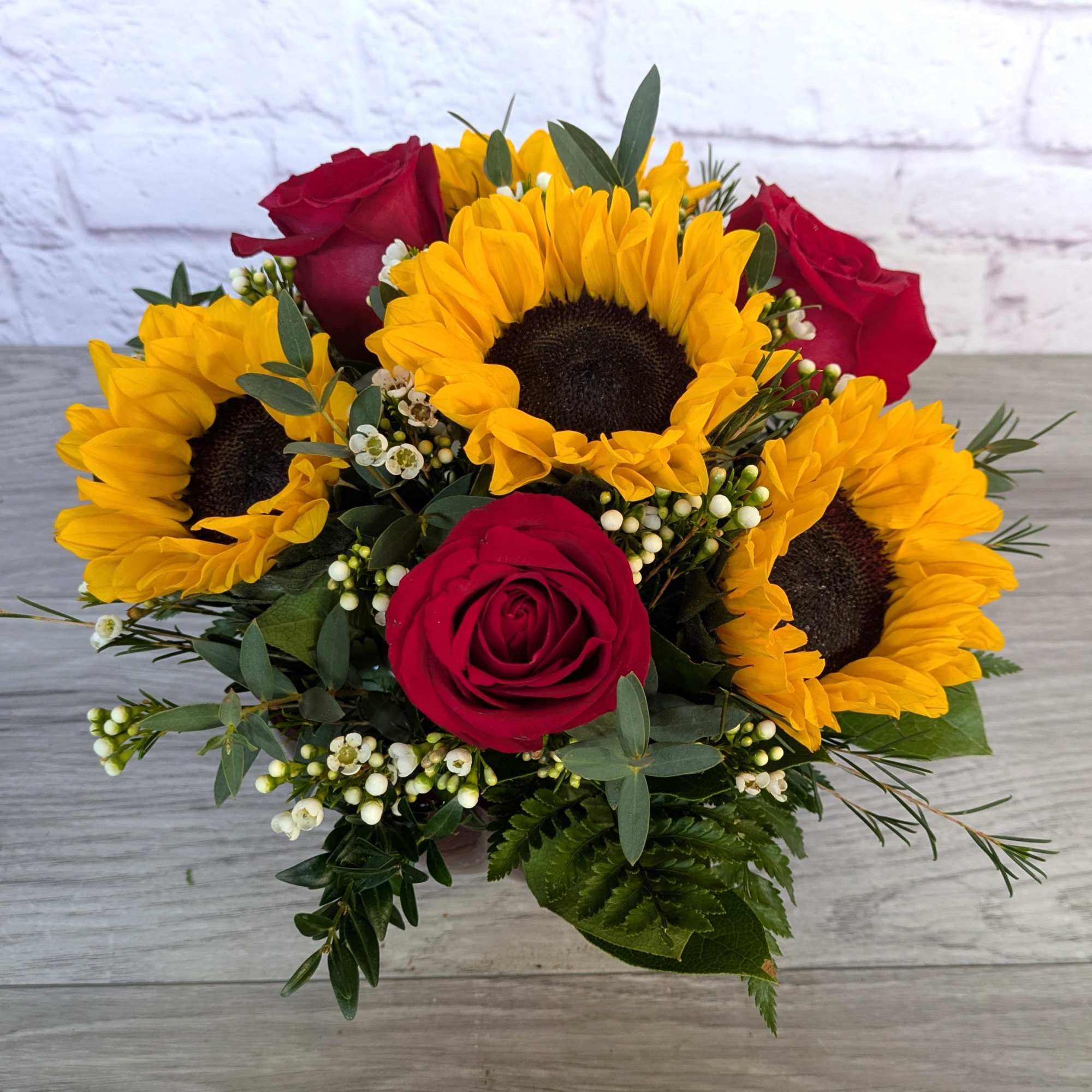 Sunflower Enchantment is A Ladybug exclusive bouquet. Filled with sunflowers, roses, waxflower